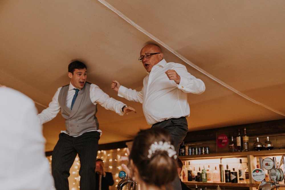 Father of the bride leads the charge at the evening party at The Normans wedding venue. Photo by Louise Anna Photography.jpg