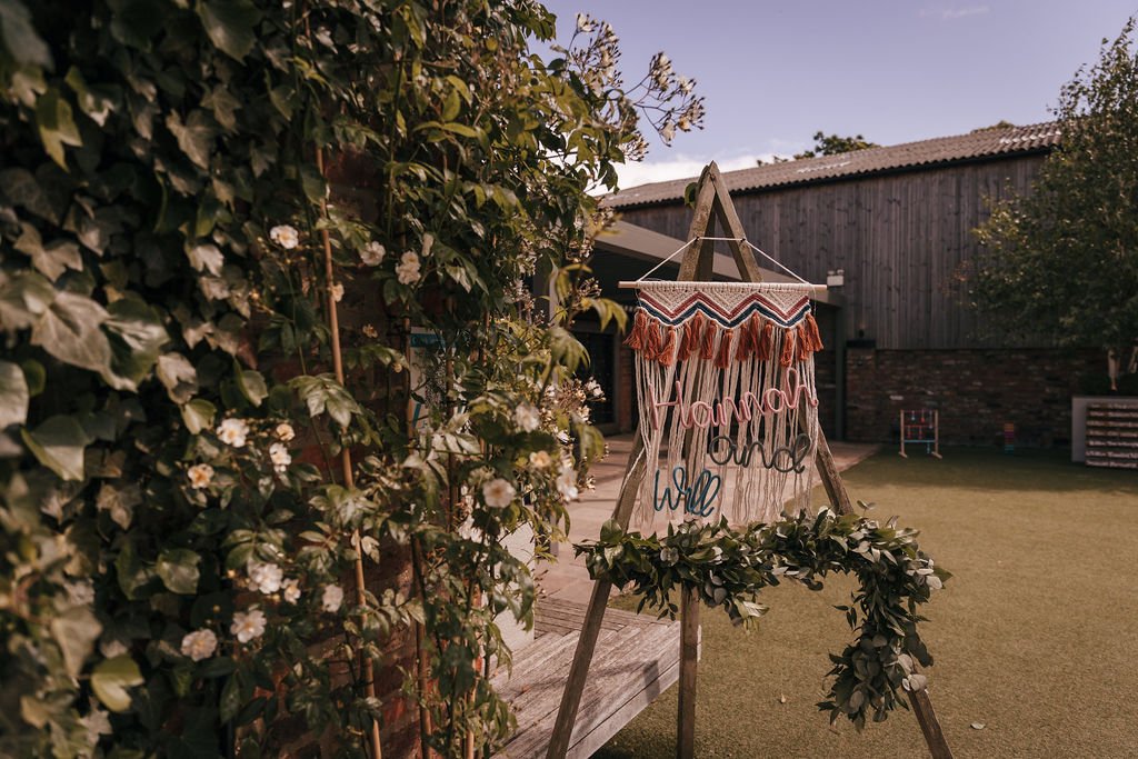 01_Welcome sign in The Courtyard at The Normans wedding venue. Photo by Jules Barron.jpg