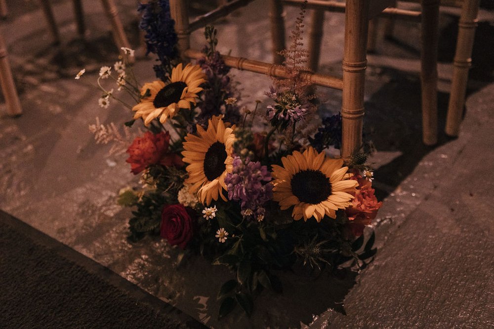 09_Beautiful bright flowers in the Ceremony Barn at The Normans wedding venue. Photo by Jules Barron.jpg