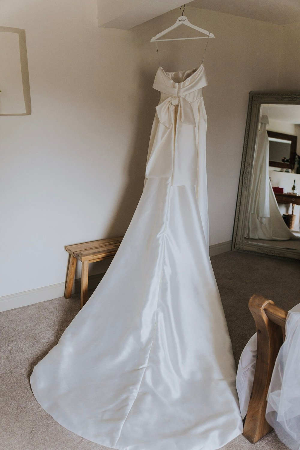 01_Wedding dress hangs in The Normans Cottage. Photo by Charlotte White.jpg