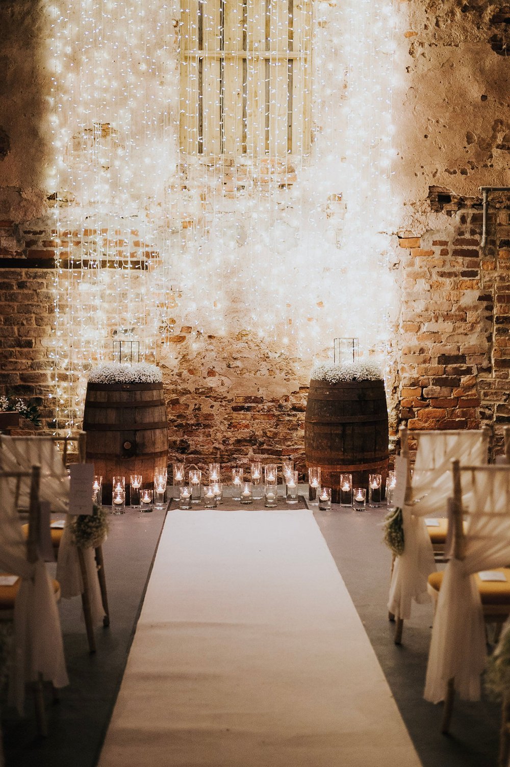 03_White aisle runner and candles in The Normans Ceremony Barn. Photo by Charlotte White.jpg