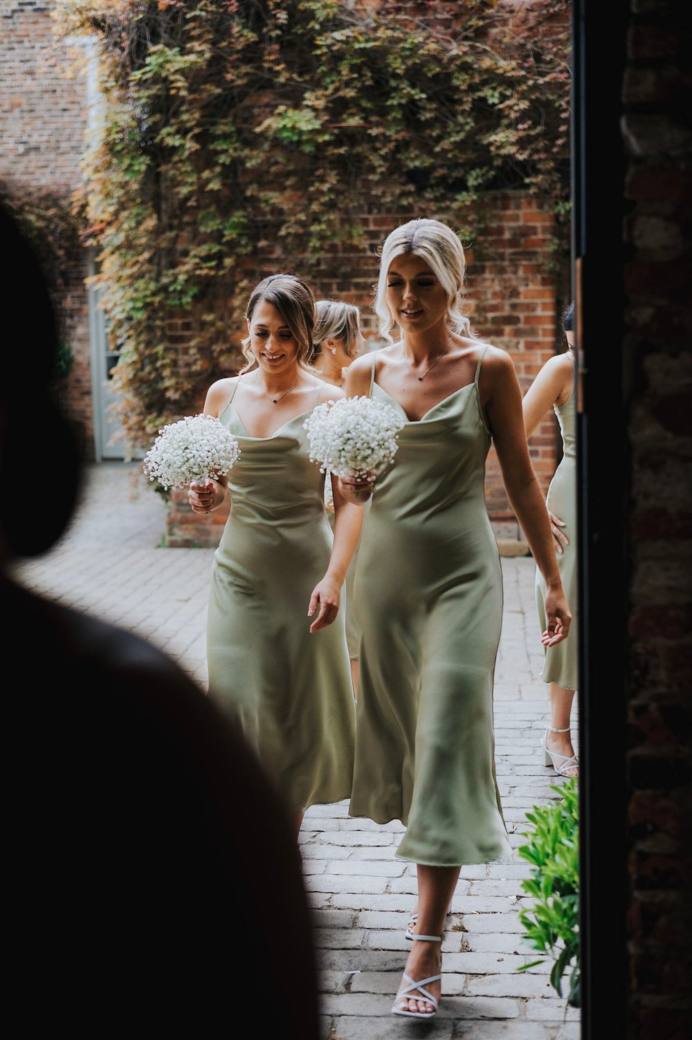 04_Bridesmaids make their way to The Ceremony Barn. Photo by Charlotte White (2).jpg