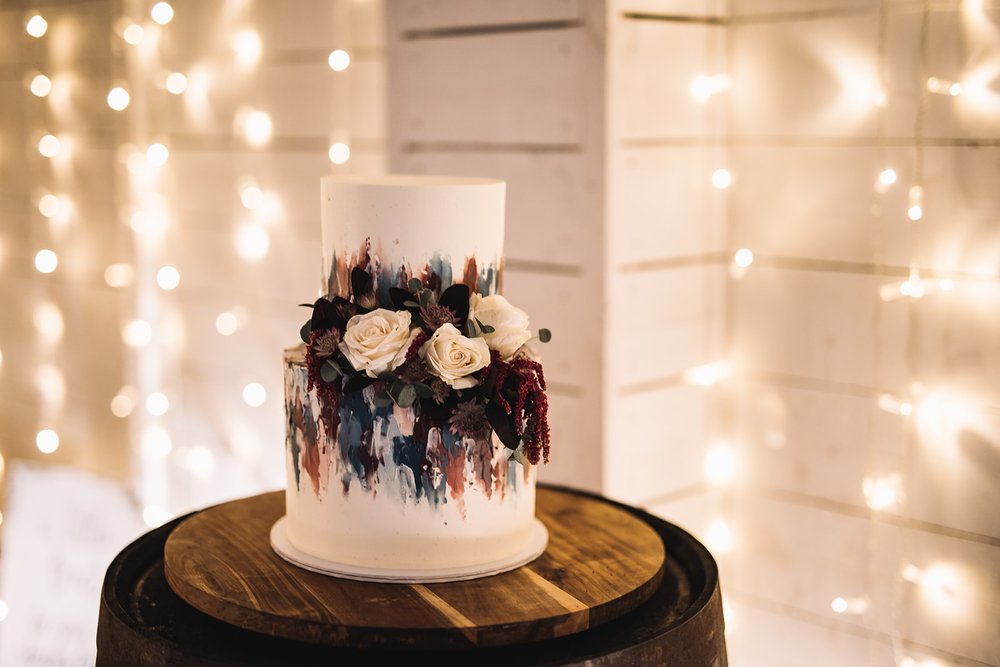 31_Wedding cake in The Normans wedding venue Grain Shed. Photo by Lumiere Photographic.jpg