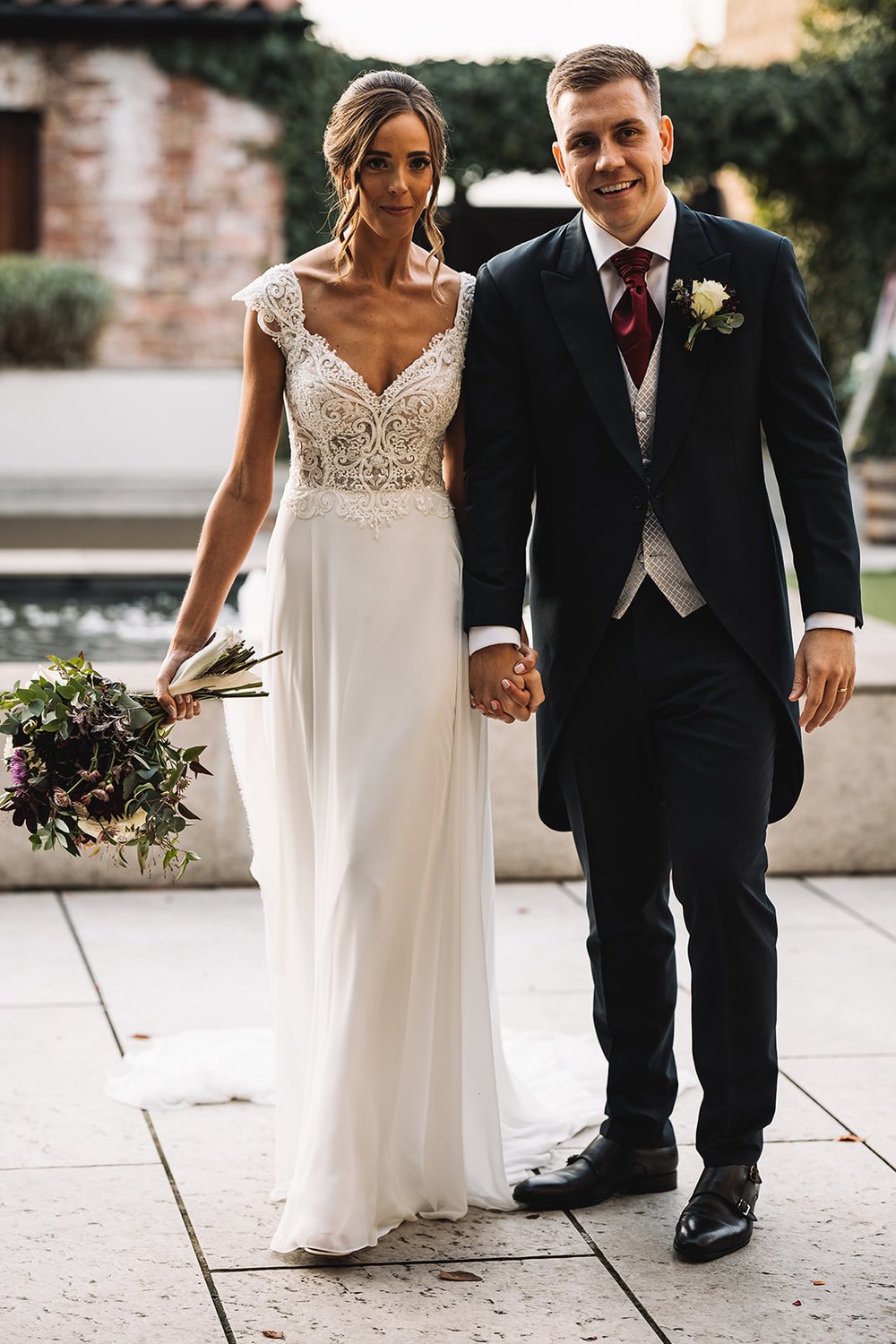 33a_Bride and groom enter The Normans wedding venue grain shed. Photo by Lumiere Photoghraphic.jpg