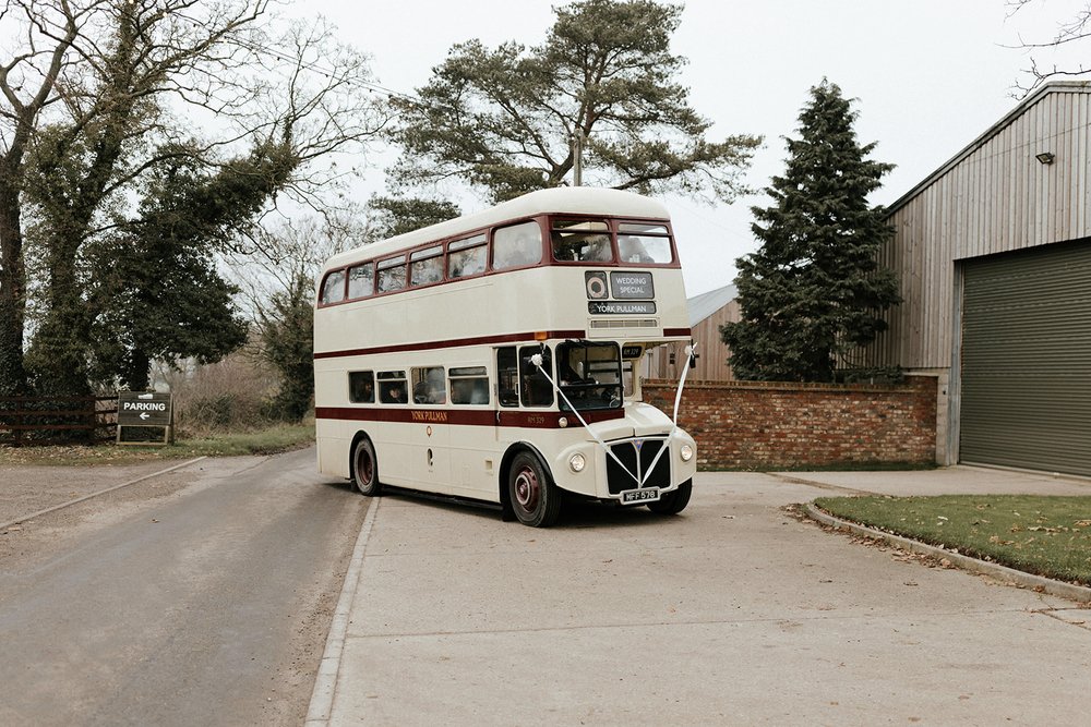 04_Wedding guests arrive at The Normans venue in double-decker bus. Photo by Monkeymole.jpg