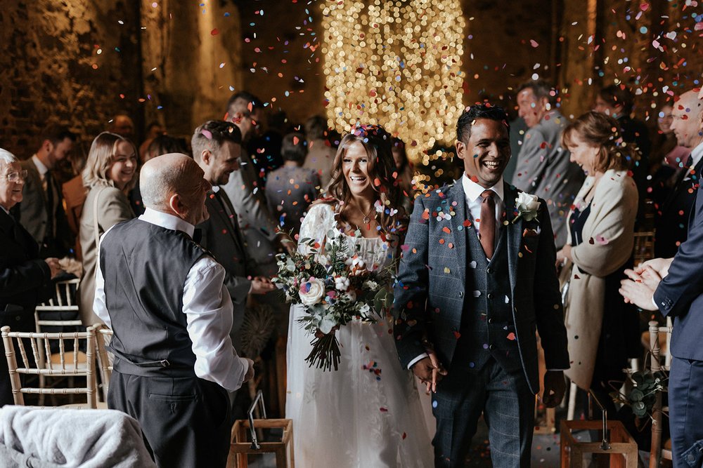 06d_Confetti is thrown as bride and groom leave The Normans wedding venue Ceremony Barn. Photo by Monkeymo (4).jpg