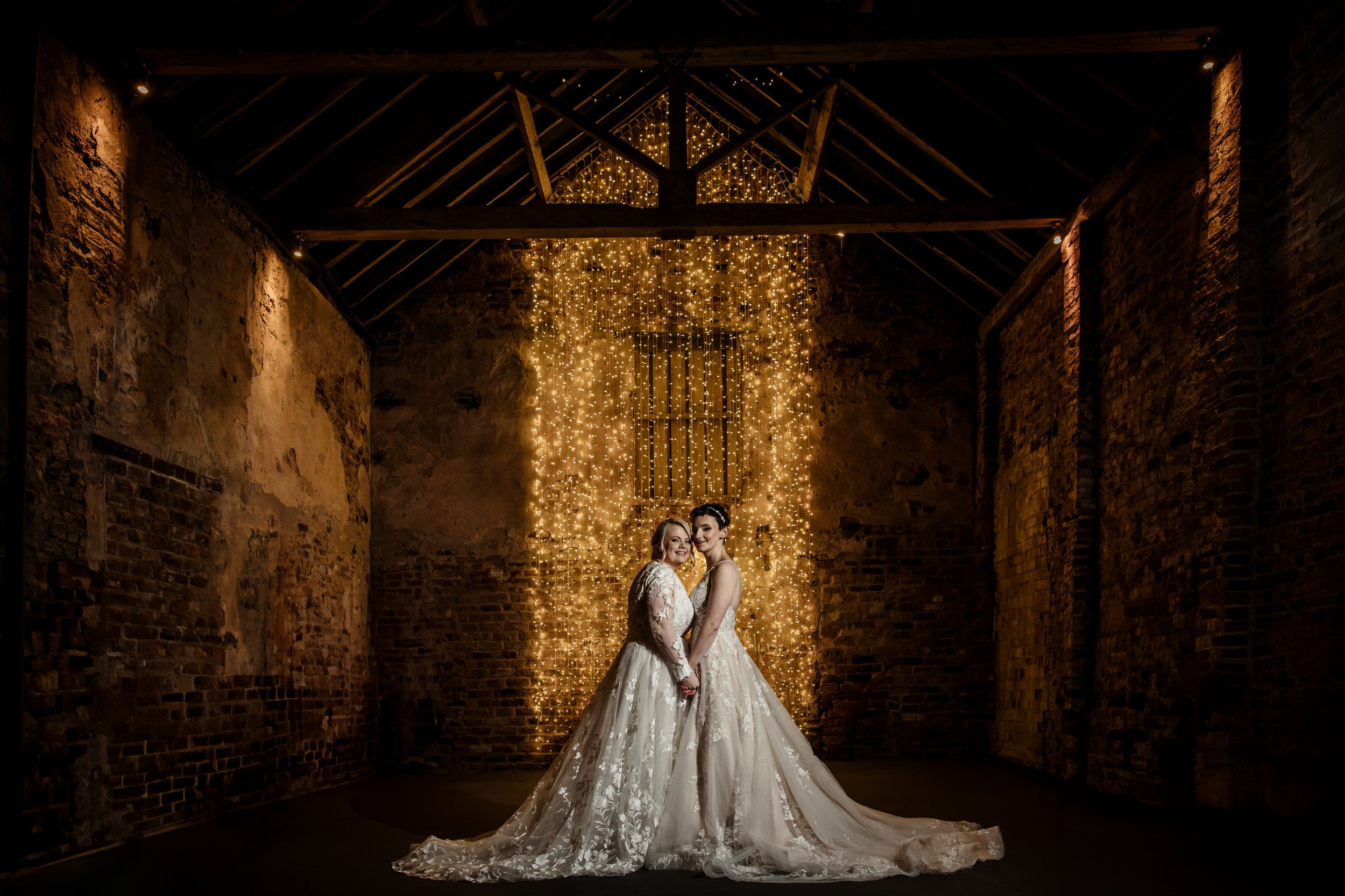 Brides in Normans wedding venue Ceremony Barn. Photo Robert Carter.jpg