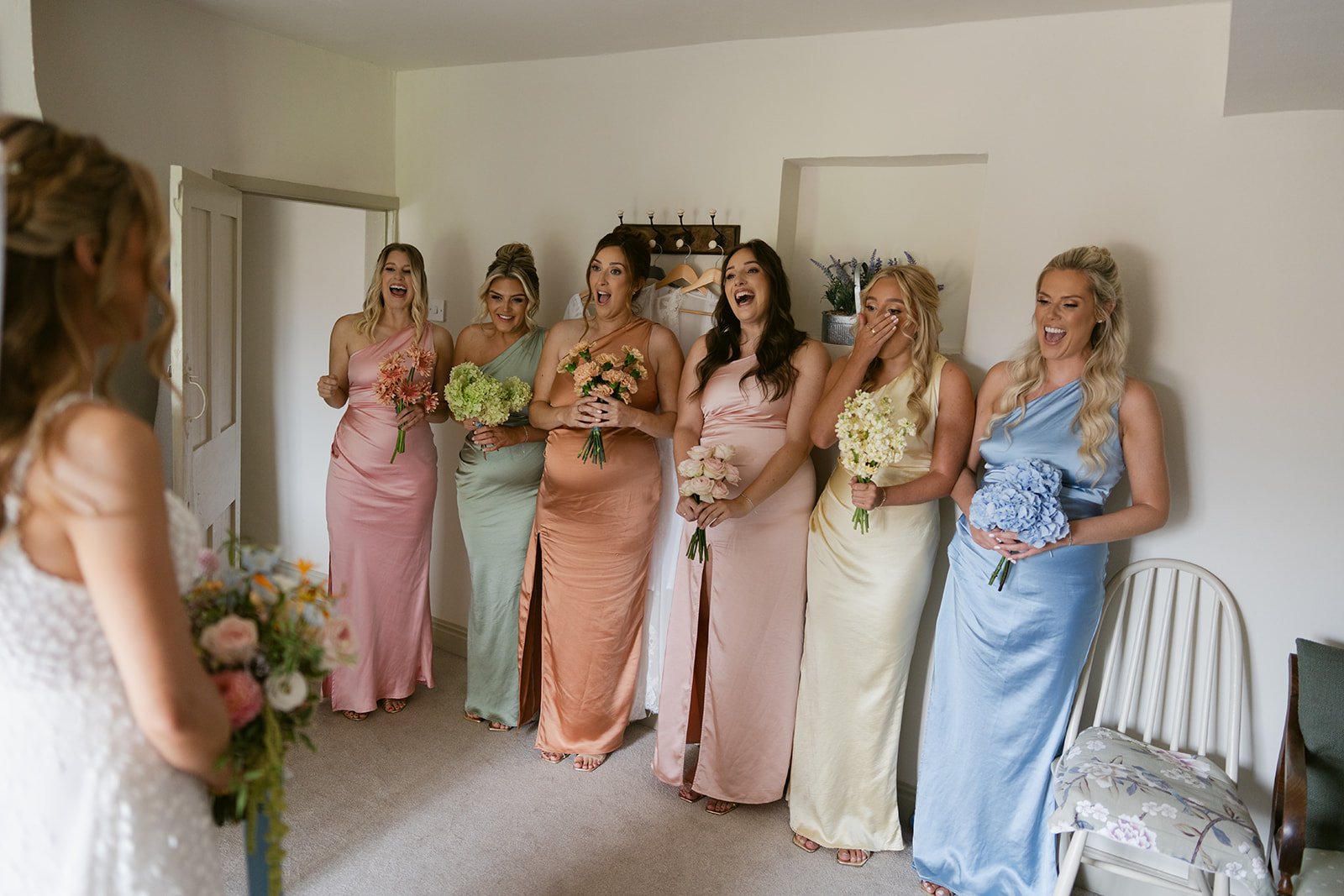 bridesmaids-first-look-pastel-rainbow-dresses.jpg