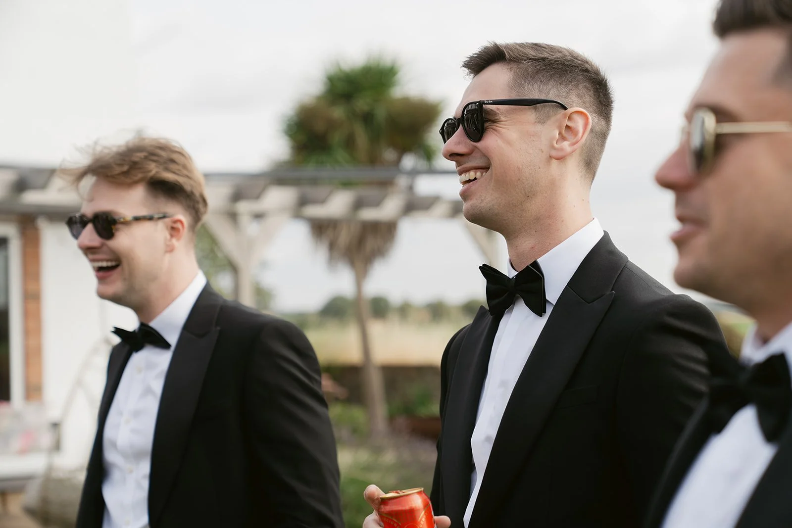 groomsmen-laughing-sunglasses-black-tie-summer-wedding.jpg