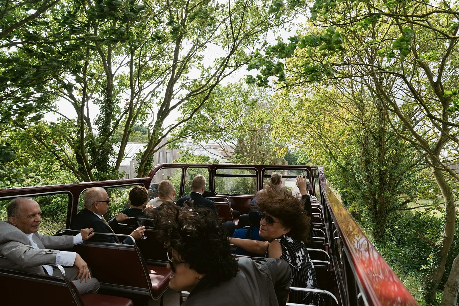 wedding-guests-open-top-vintage-bus-country-lane.jpg