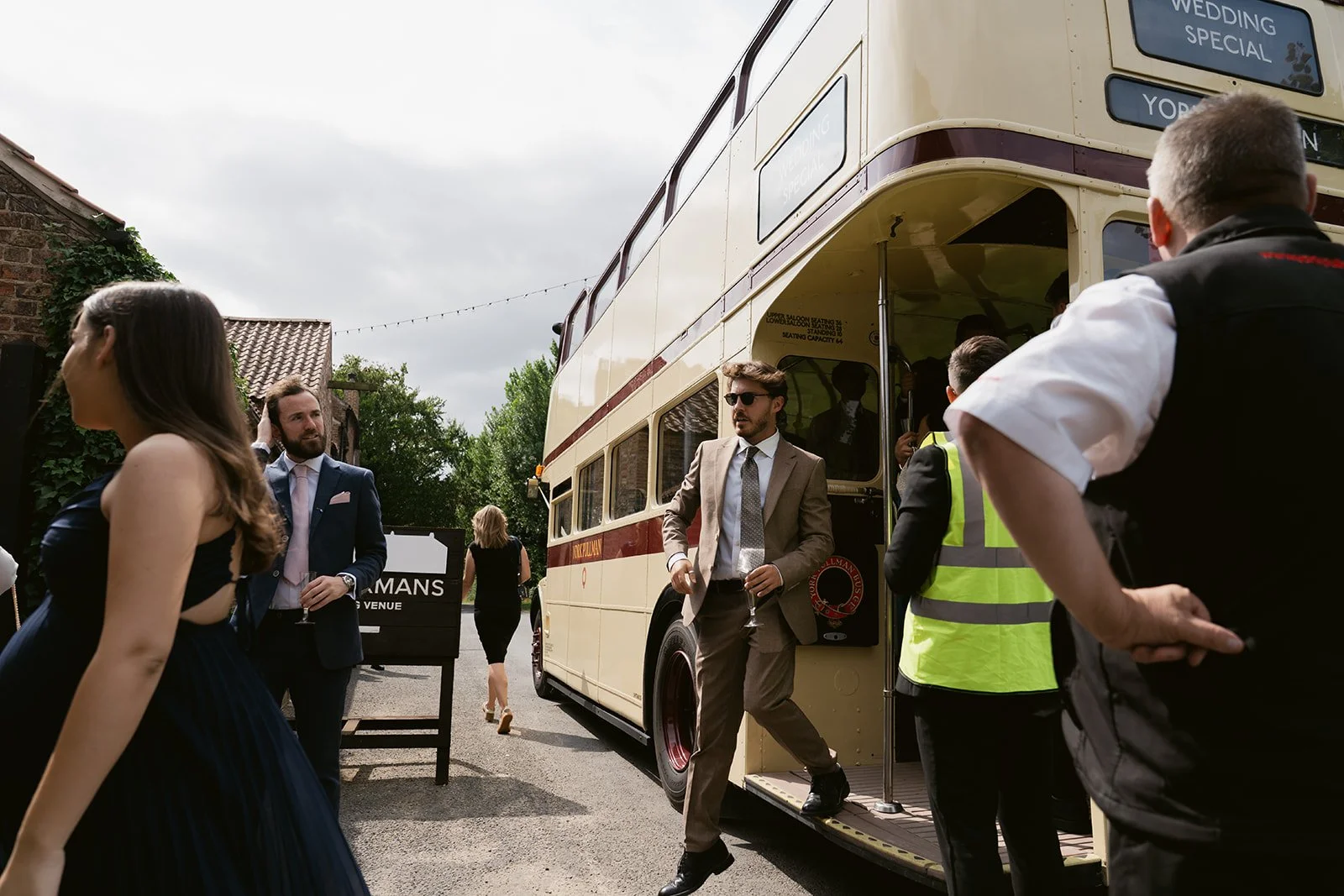 guests-arriving-vintage-double-decker-bus-the-normans.jpg