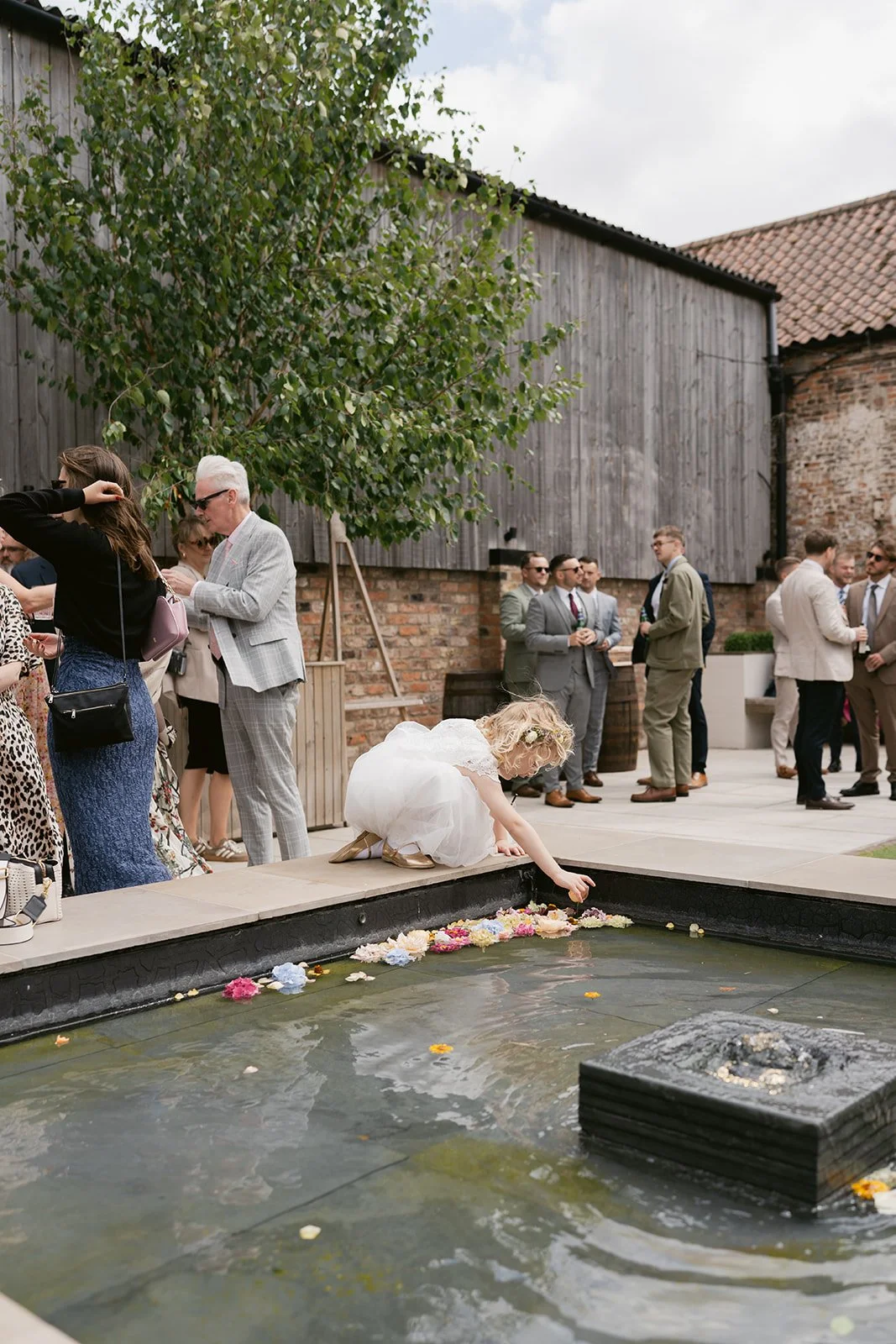 flower-girl-petals-water-feature-courtyard.jpg