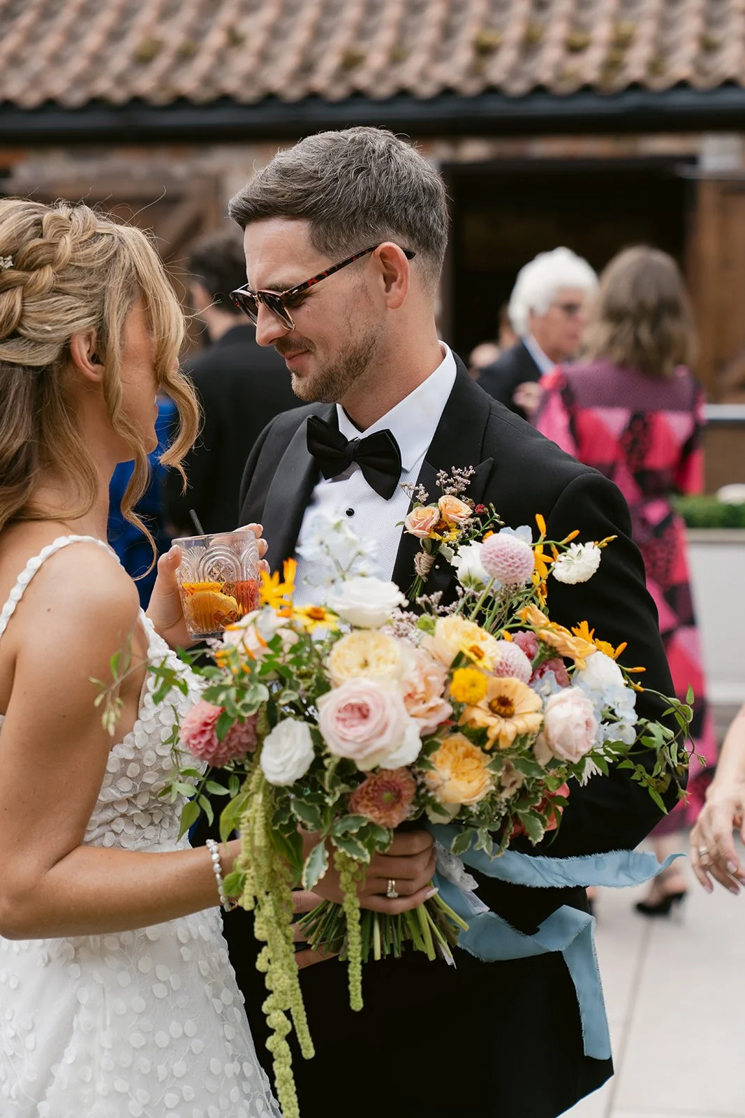 bride-groom-drinks-reception-courtyard-bouquet.jpg