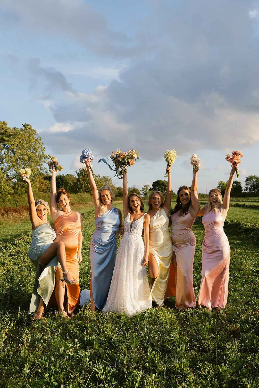bride-bridesmaids-golden-hour-field-bouquets.jpg
