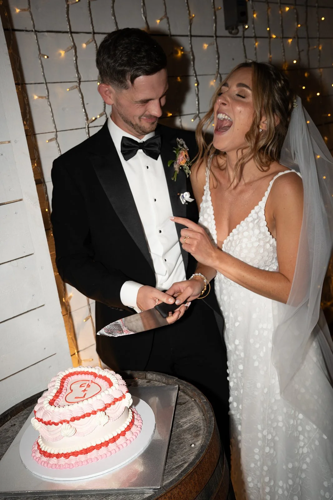bride-groom-cutting-heart-shaped-wedding-cake.jpg