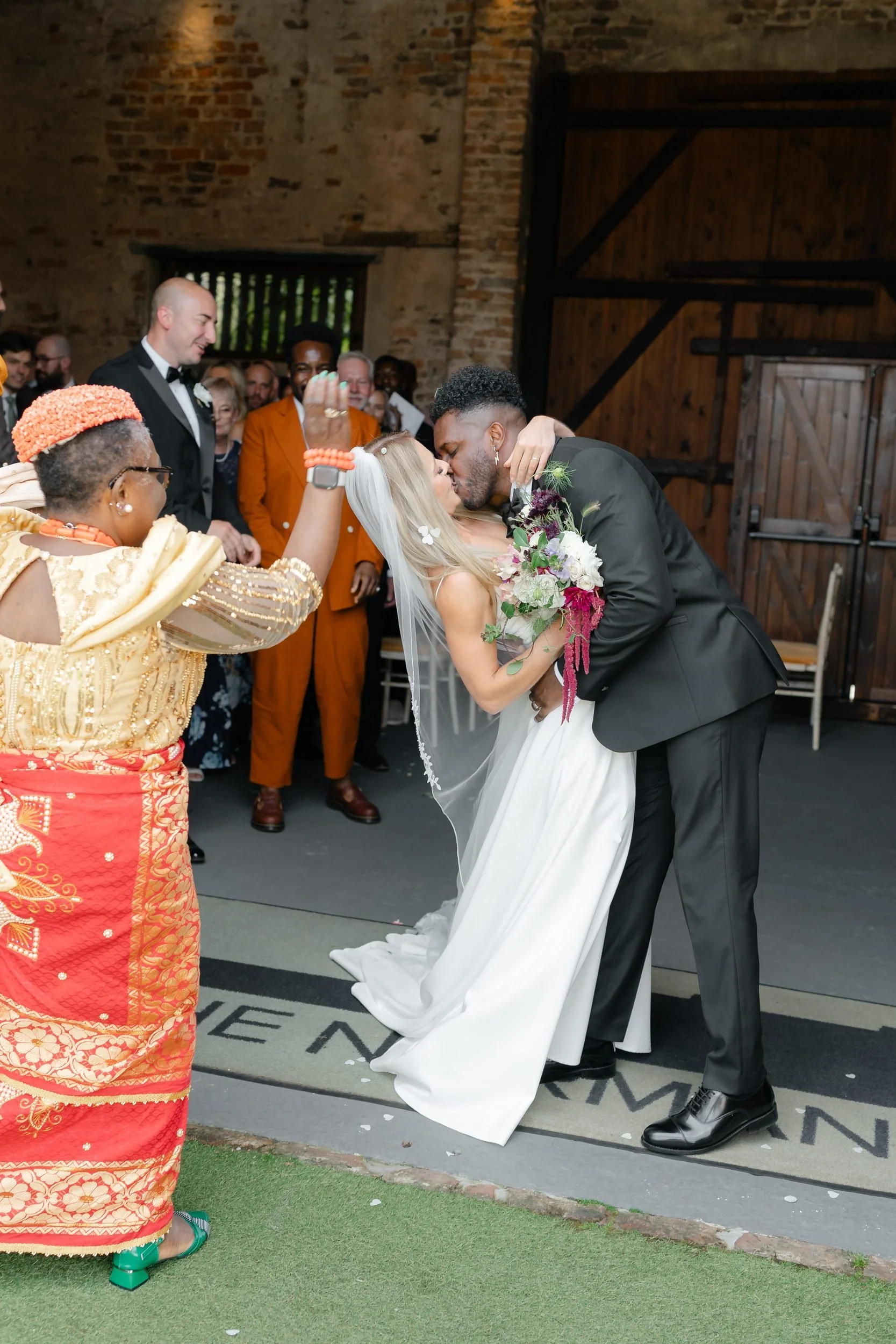 the-normans-bride-groom-kiss-barn-doors-family-celebrating-397.jpg