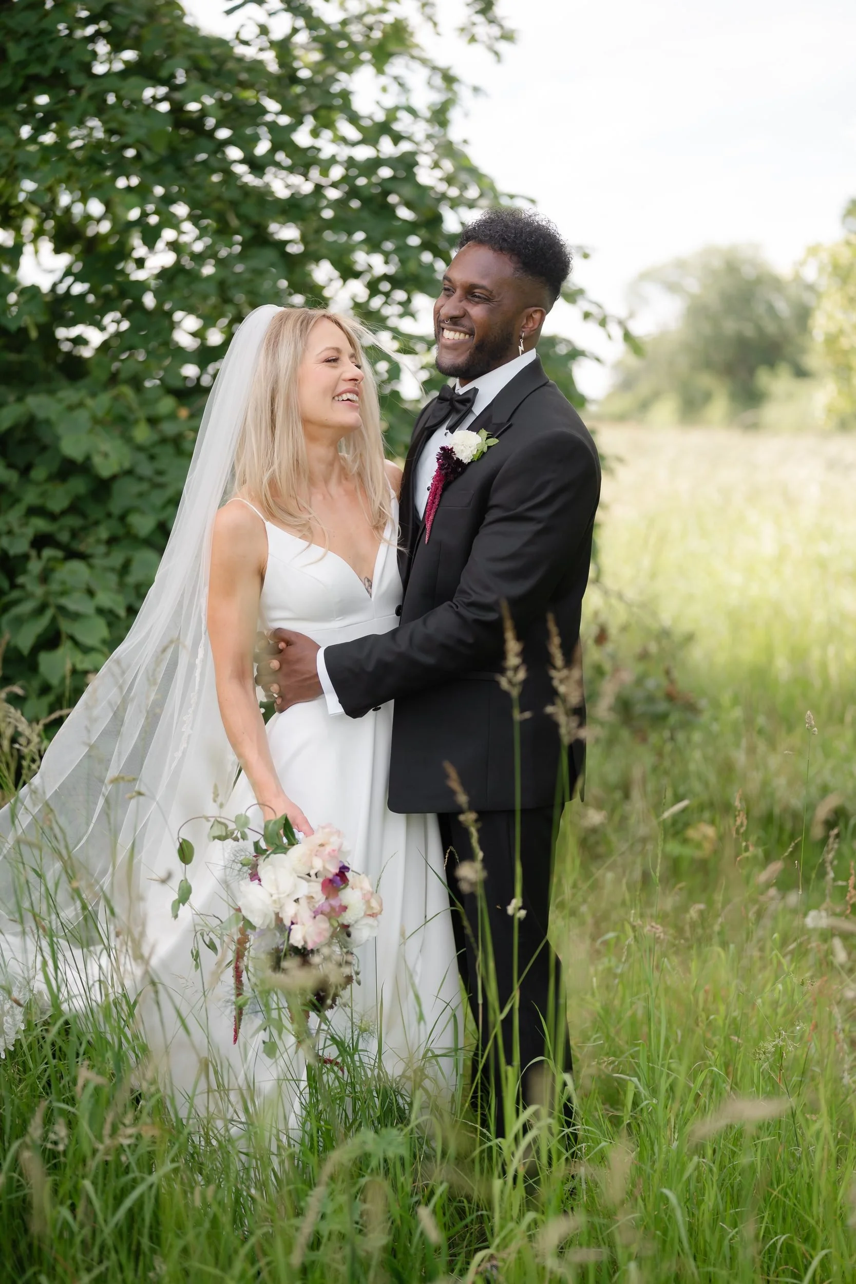 the-normans-bride-groom-laughing-wildflower-meadow-portrait-584.jpg