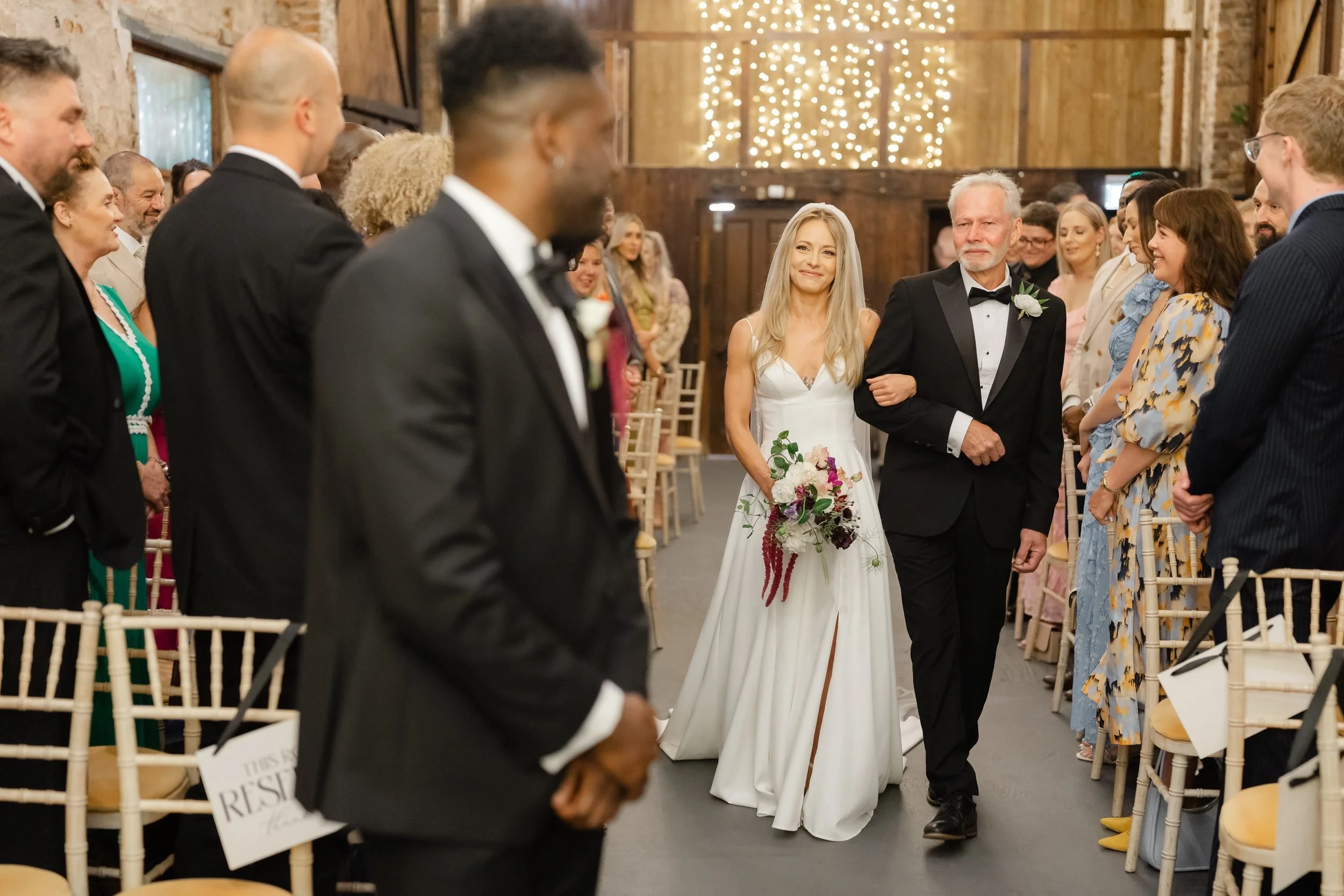 the-normans-bride-walking-down-aisle-with-father-barn-york-298.jpg