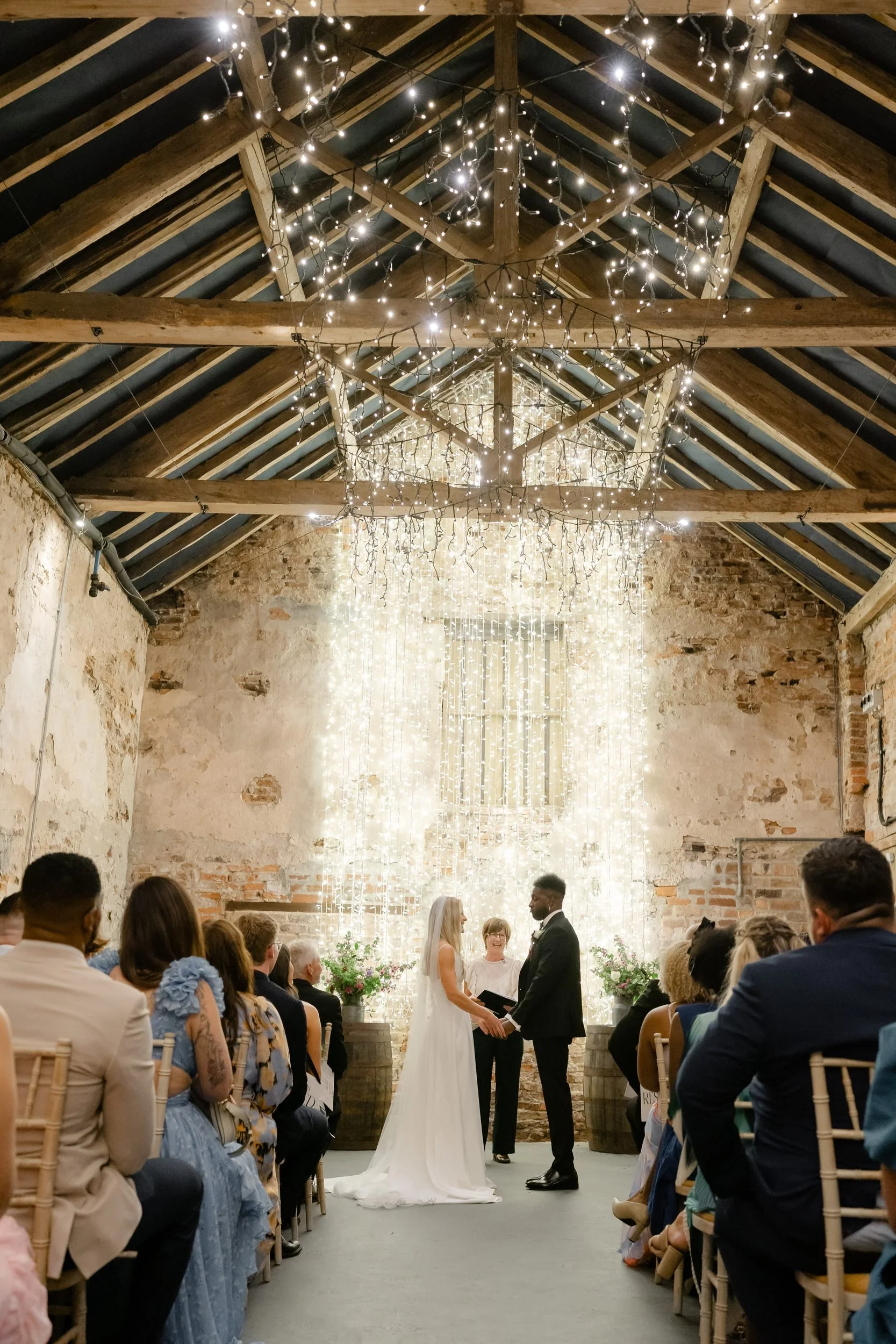 the-normans-ceremony-barn-oak-beams-fairy-lights-couple-vows-318.jpg
