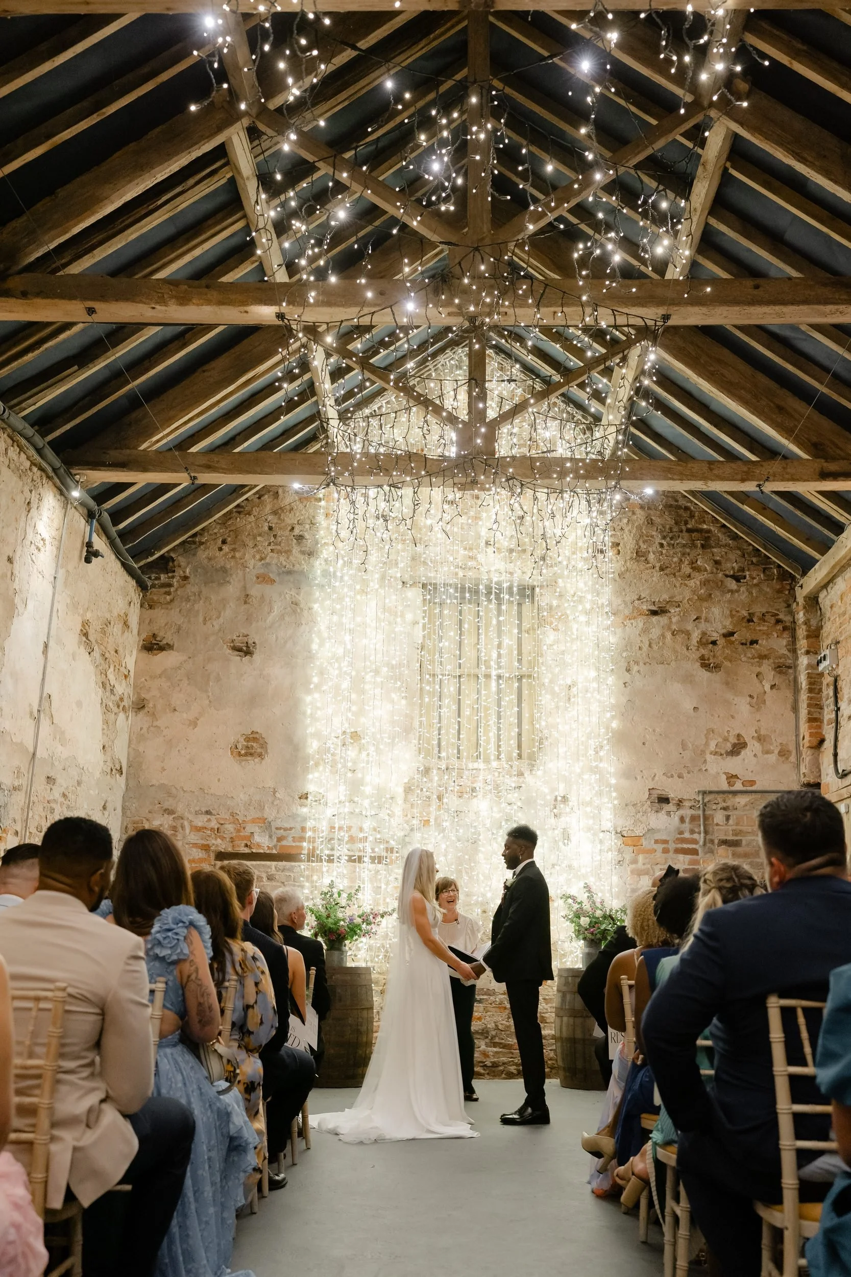 the-normans-wedding-ceremony-fairy-light-wall-rustic-barn-york-316.jpg