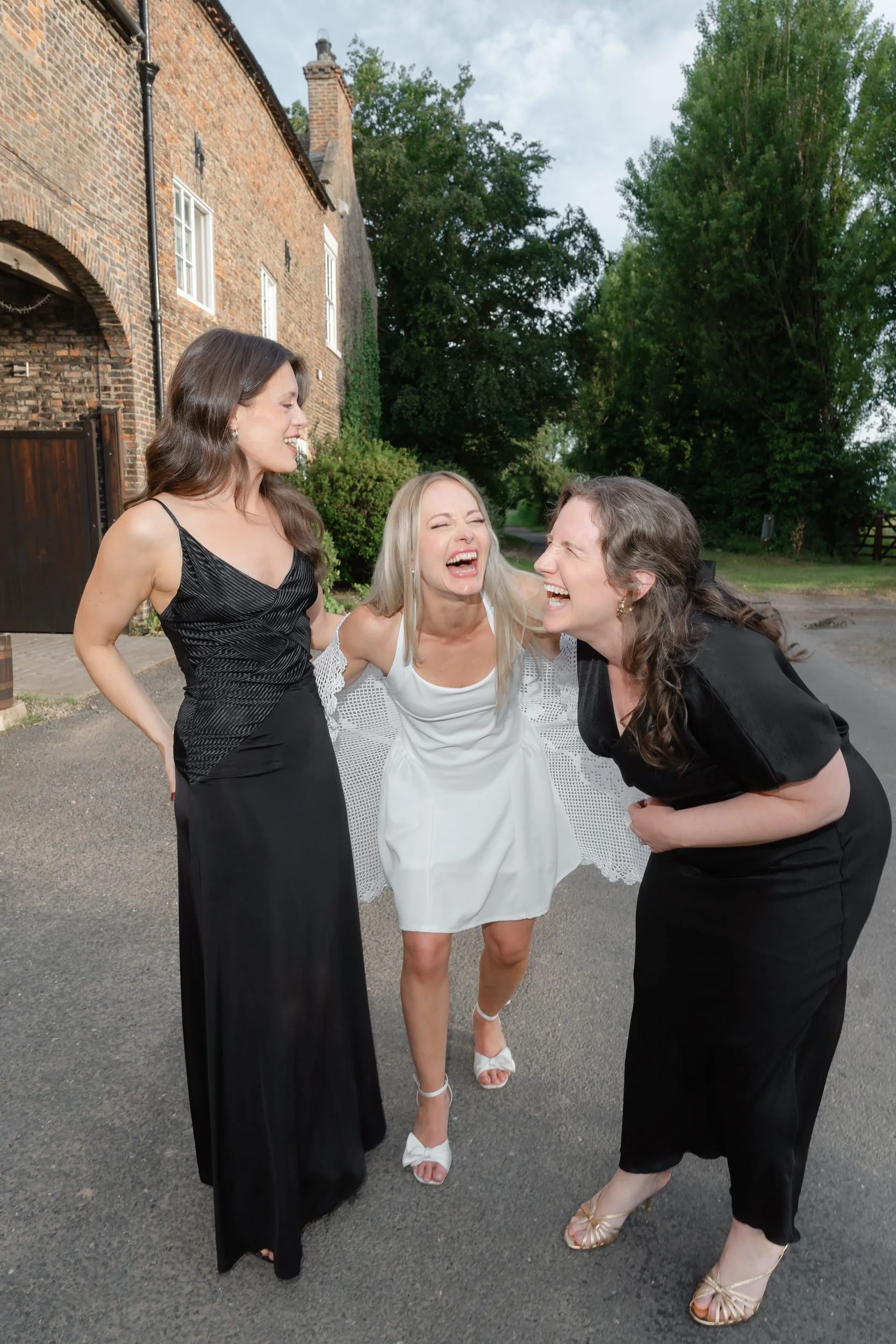 the-normans-bride-bridesmaids-laughing-farm-lane-evening-999.jpg