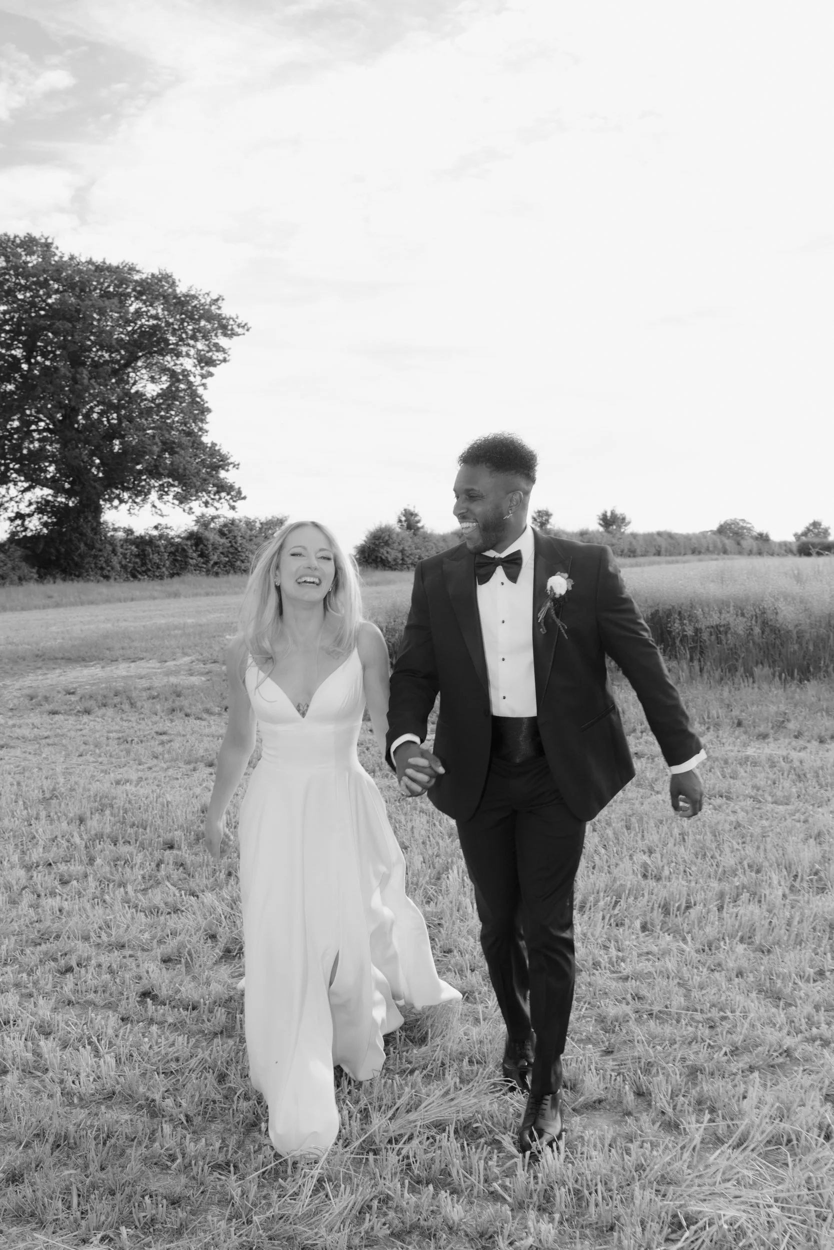 the-normans-bride-groom-walking-field-black-and-white-yorkshire-951.jpg