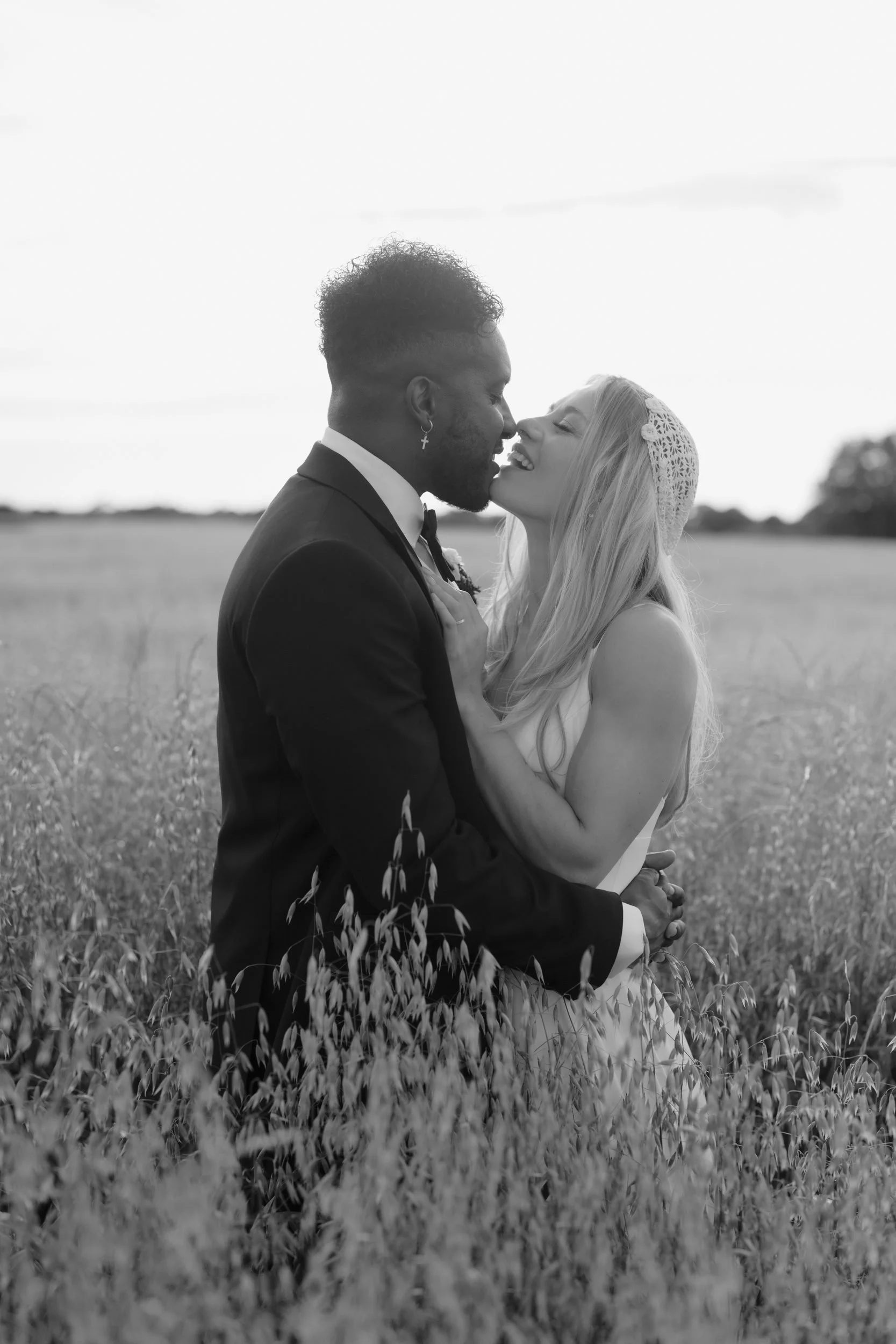 the-normans-couple-kiss-golden-hour-field-black-and-white-897.jpg