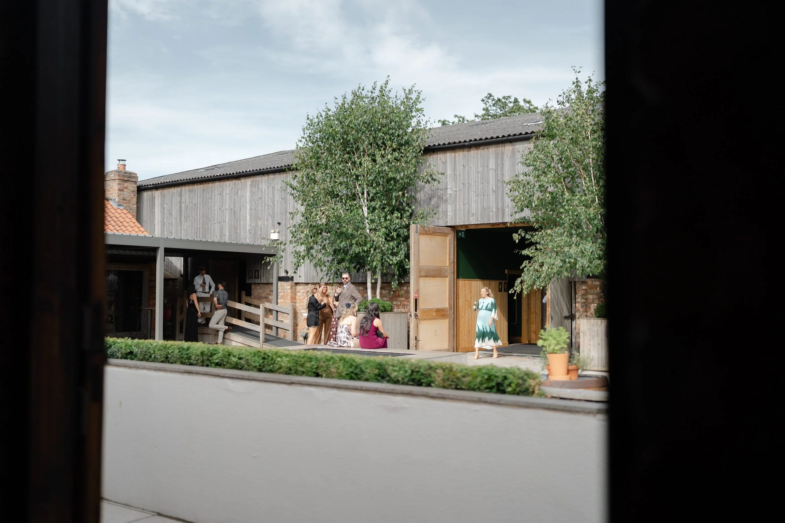 the-normans-timber-barn-courtyard-evening-guests-889.jpg