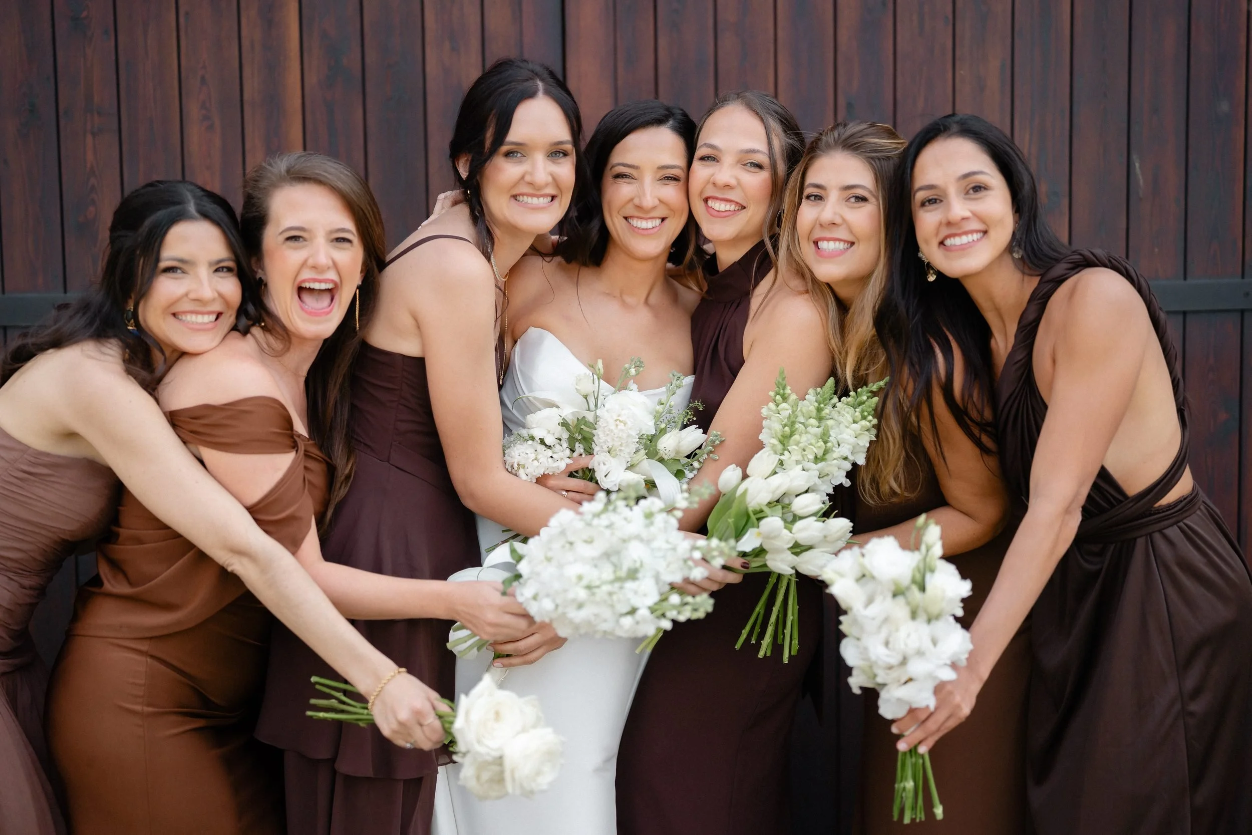 bridal-party-hugging-laughing-barn-doors-472.jpg
