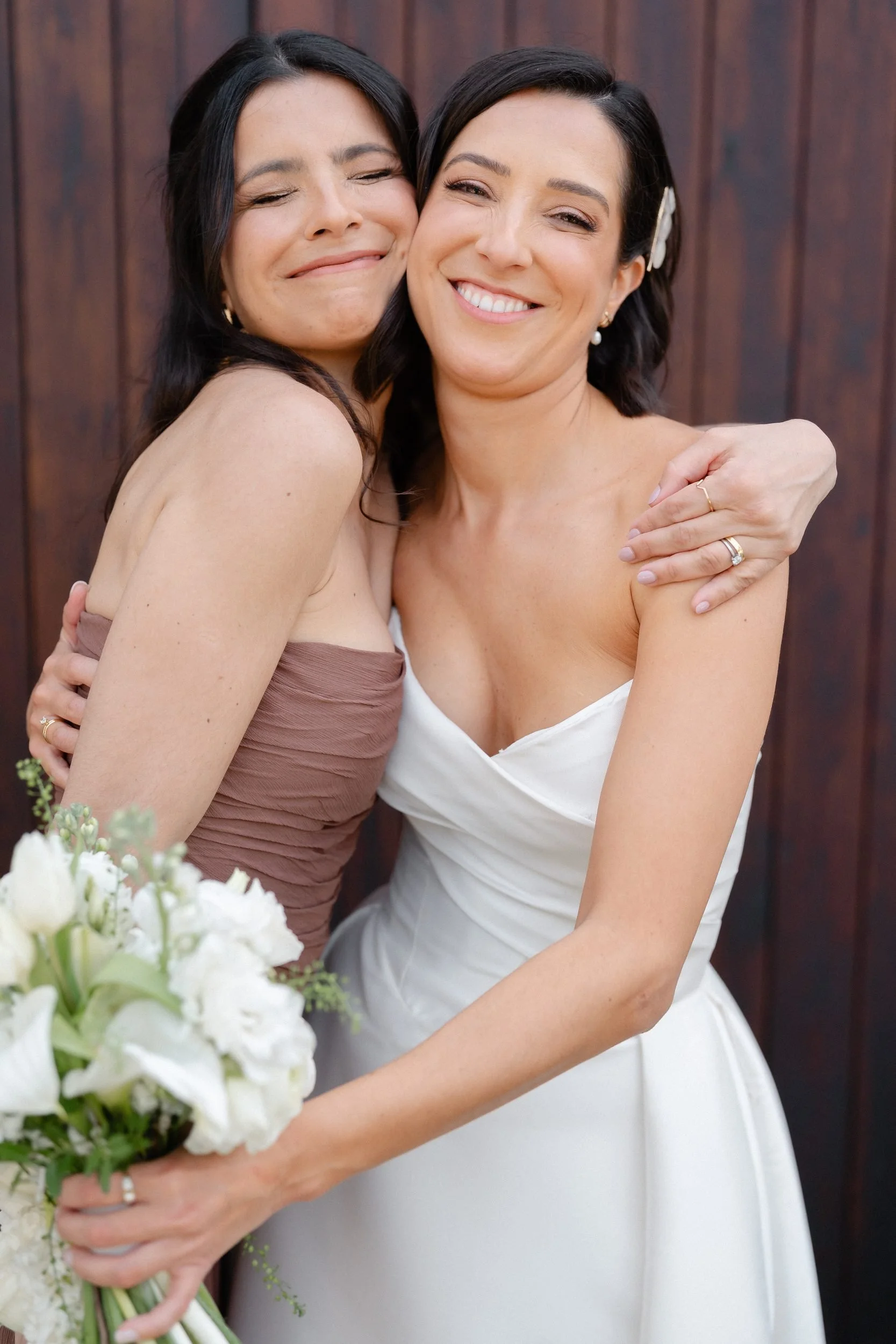 bride-and-bridesmaid-hug-white-bouquet-478.jpg