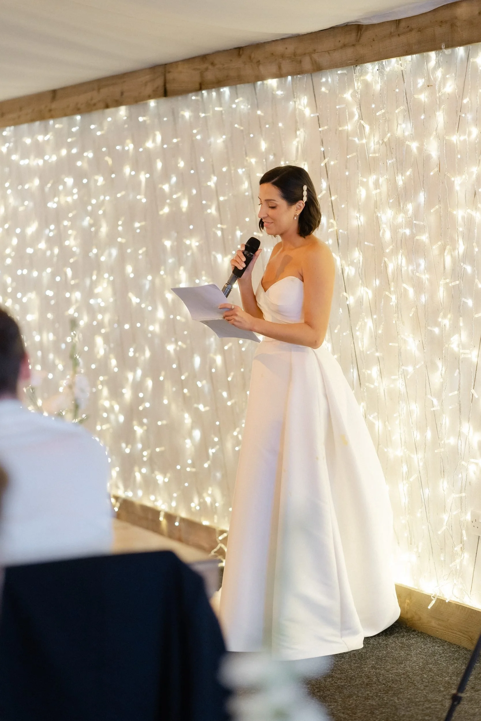 bride-giving-speech-fairy-light-backdrop-805.jpg