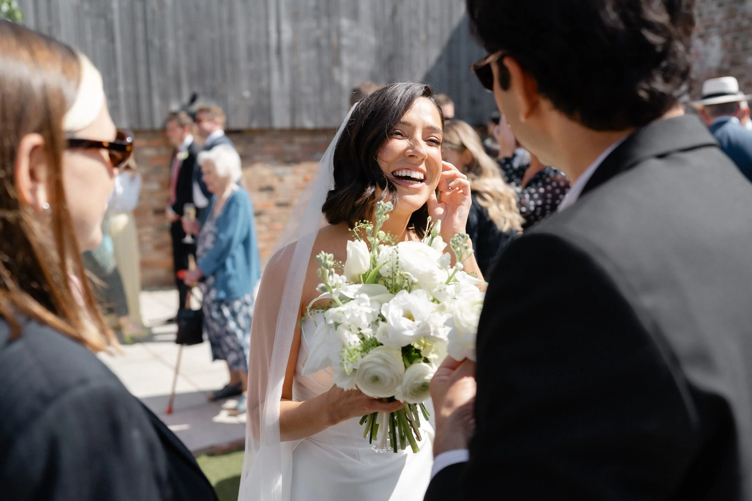 bride-laughing-drinks-reception-courtyard-375.jpg