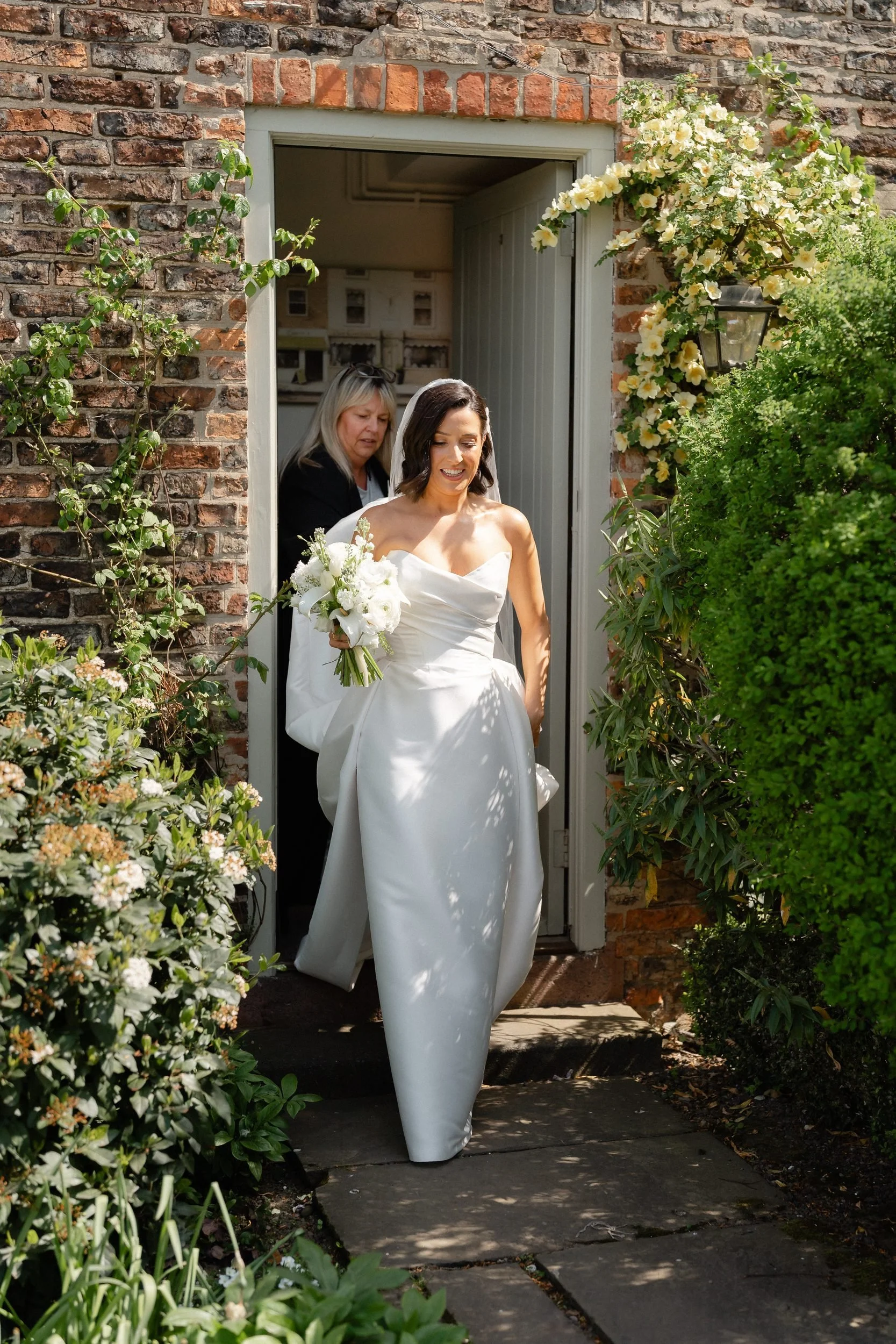 bride-leaving-bridal-cottage-doorway-the-normans-246.jpg