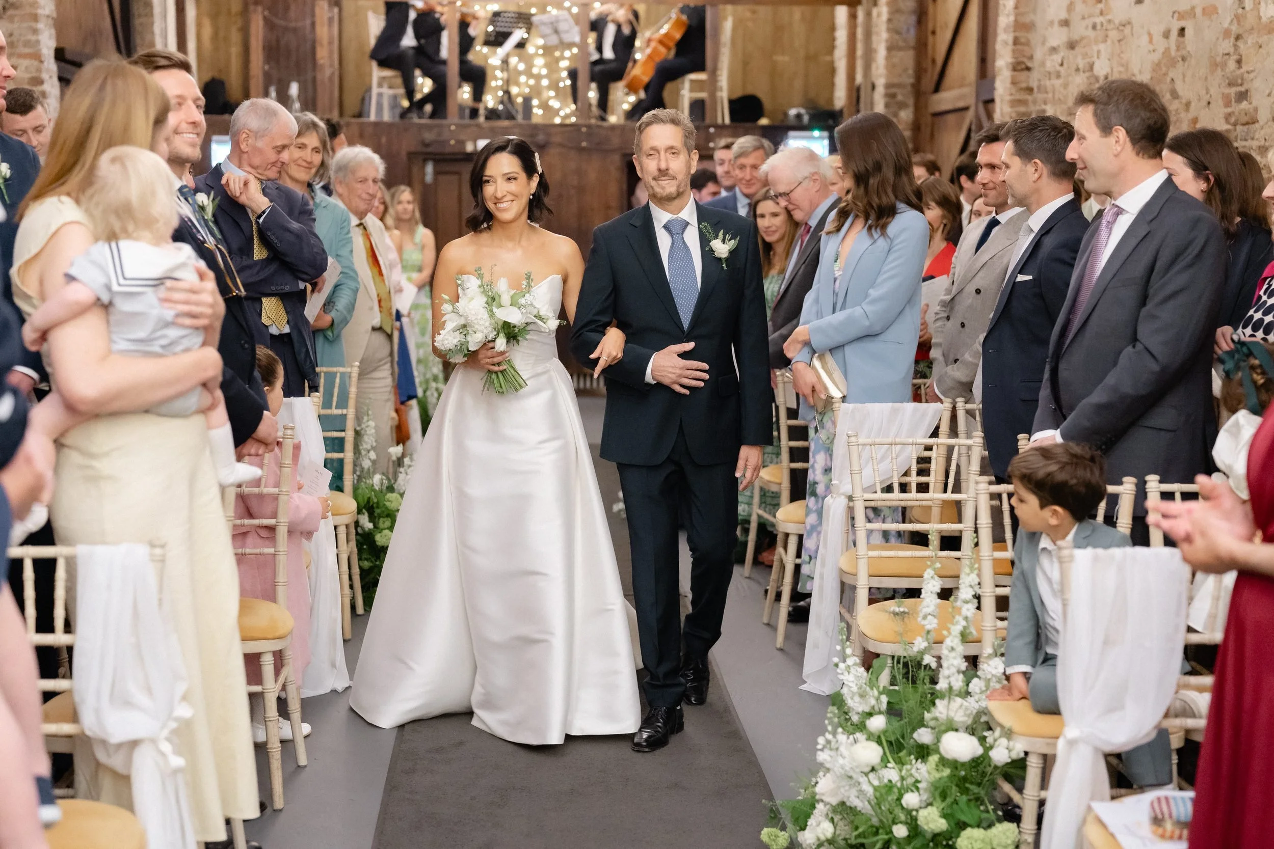 father-walks-bride-down-aisle-fairy-light-barn-291.jpg