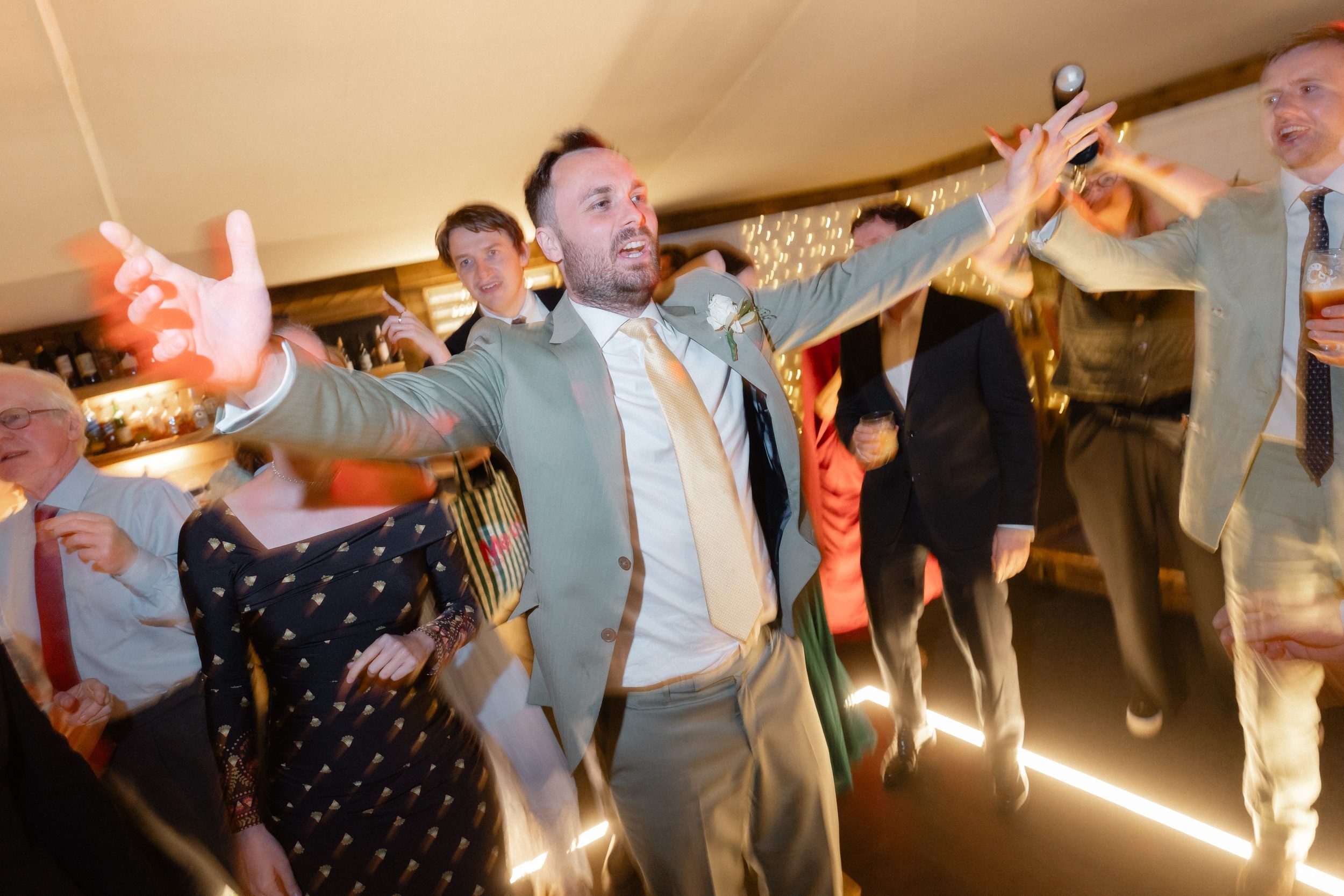 groom-arms-out-dancing-evening-party-878.jpg