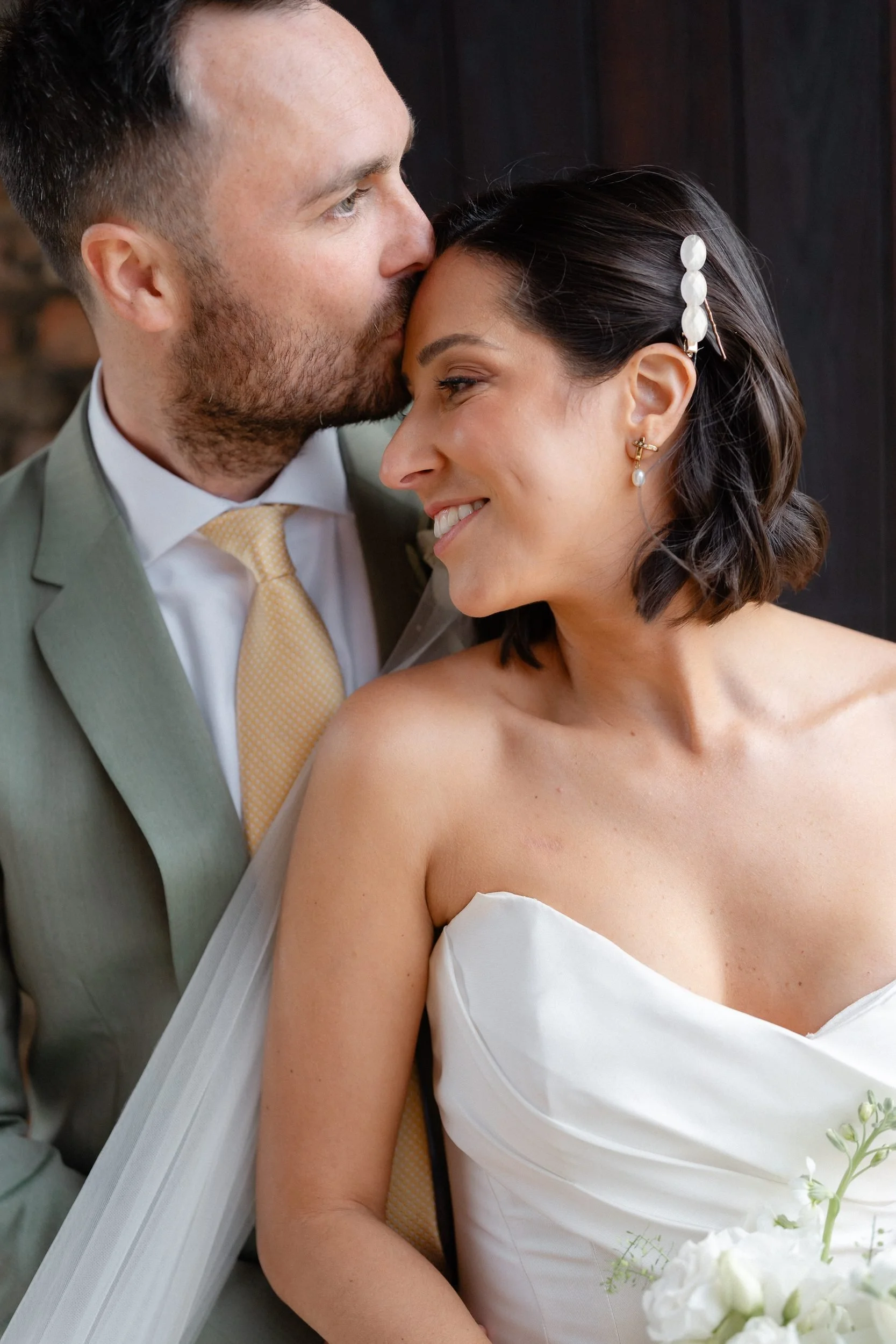 groom-kisses-bride-forehead-barn-doors-589.jpg
