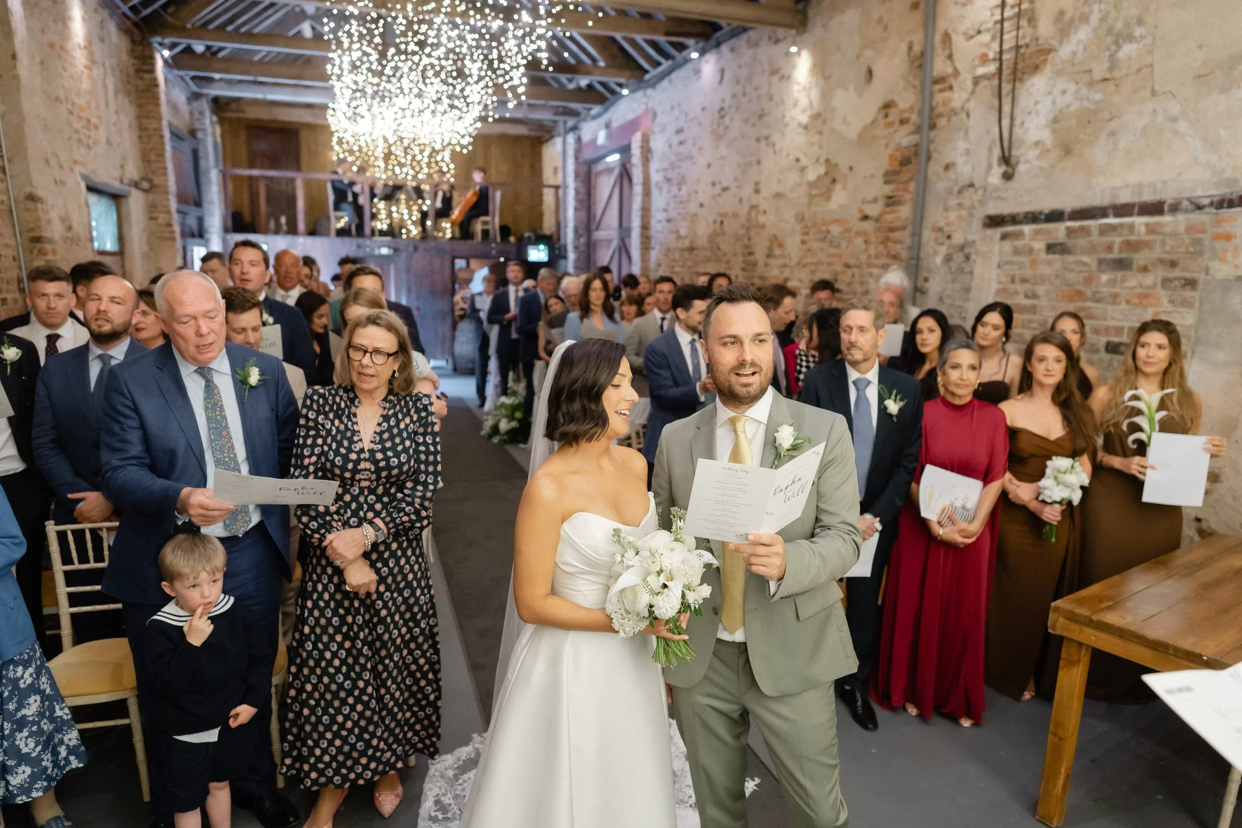 just-married-couple-walk-back-up-aisle-barn-319.jpg