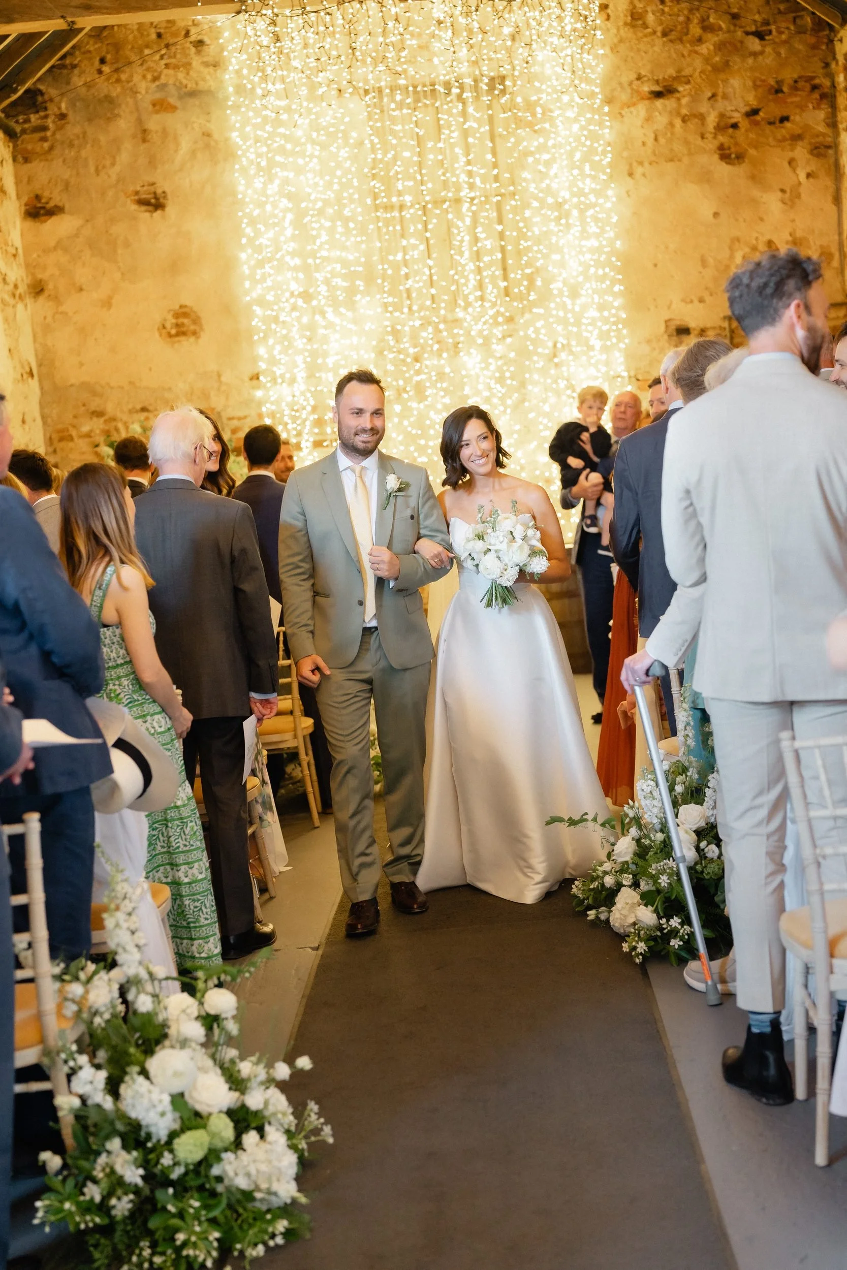 newlyweds-walking-down-aisle-fairy-light-curtain-352.jpg