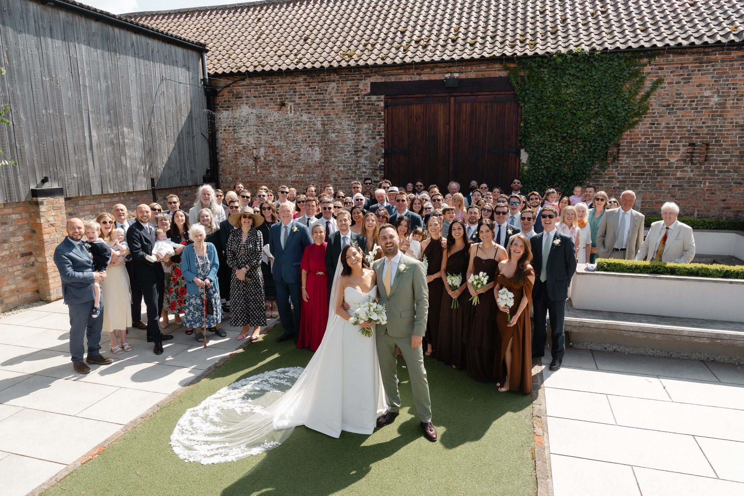 whole-wedding-party-group-photo-courtyard-the-normans-372.jpg