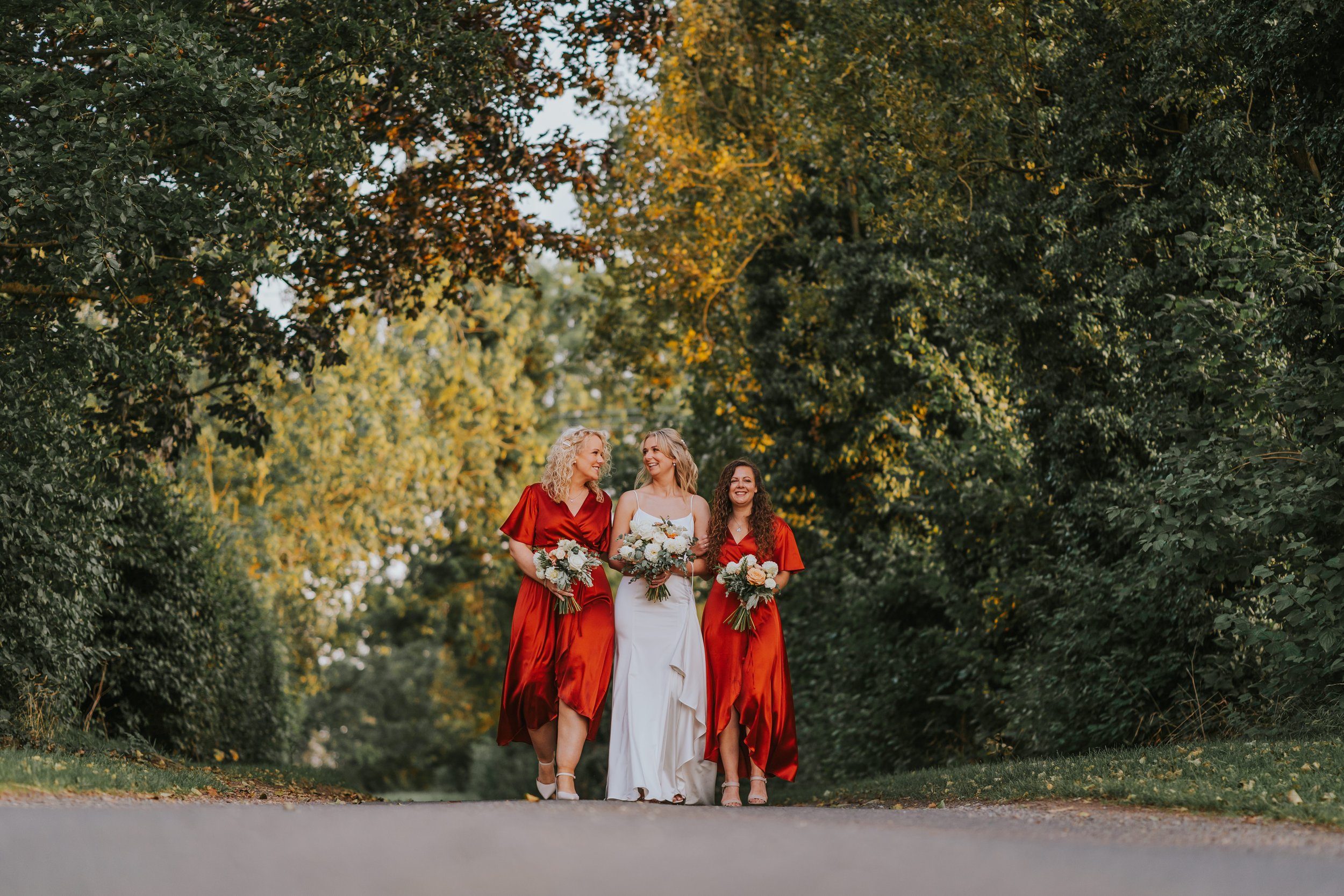 Bride with her bridesmaids standing outside The Normans wedding venue, York. dotandscolly.co.uk