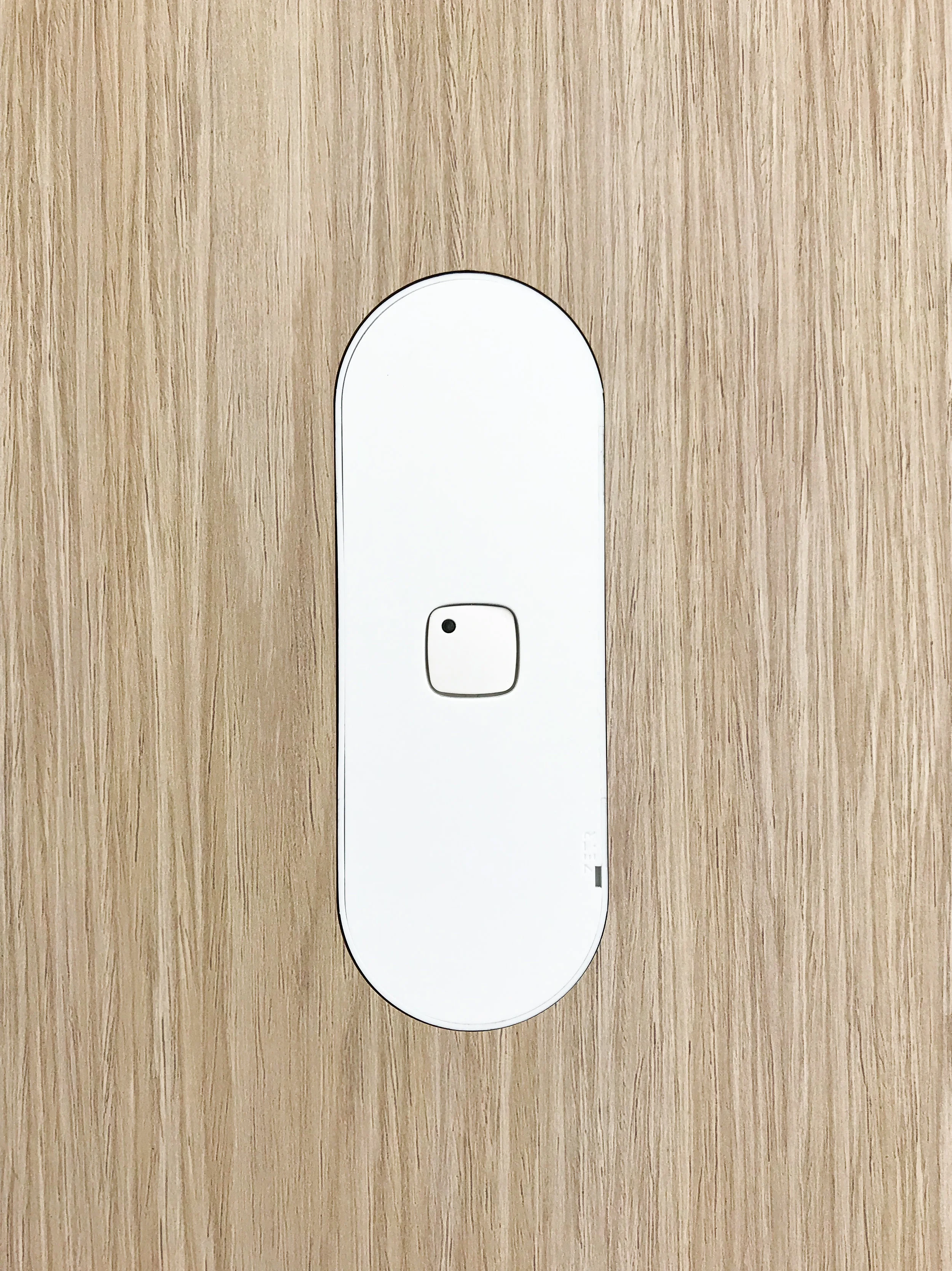 ZETR one gang switch in matte white finishing flush in veneer with our adjustable mounting assembly. 