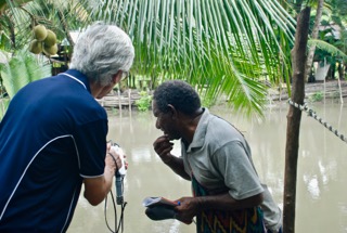 Martin Brezger conducts river water tests with a tribal leader. PHOTO: Madeleine Brezger