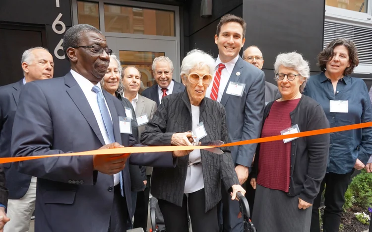 Howard Amron's widow, Joan Amron cuts the ribbon for the Howard Amron House with Council Ben Kallos,&nbsp;Urban Pathways CEO Fred Shack, family and board members looking on.&nbsp;&nbsp;