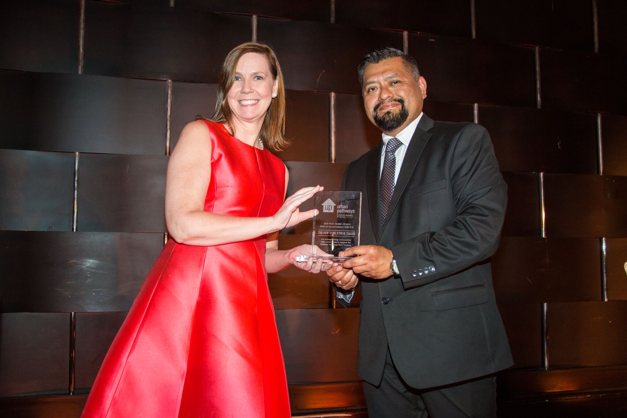Suzanne accepting the Way Home Award for Humanitarian Service given by Ivan Shapiro's Program Director Marcos Campos. 