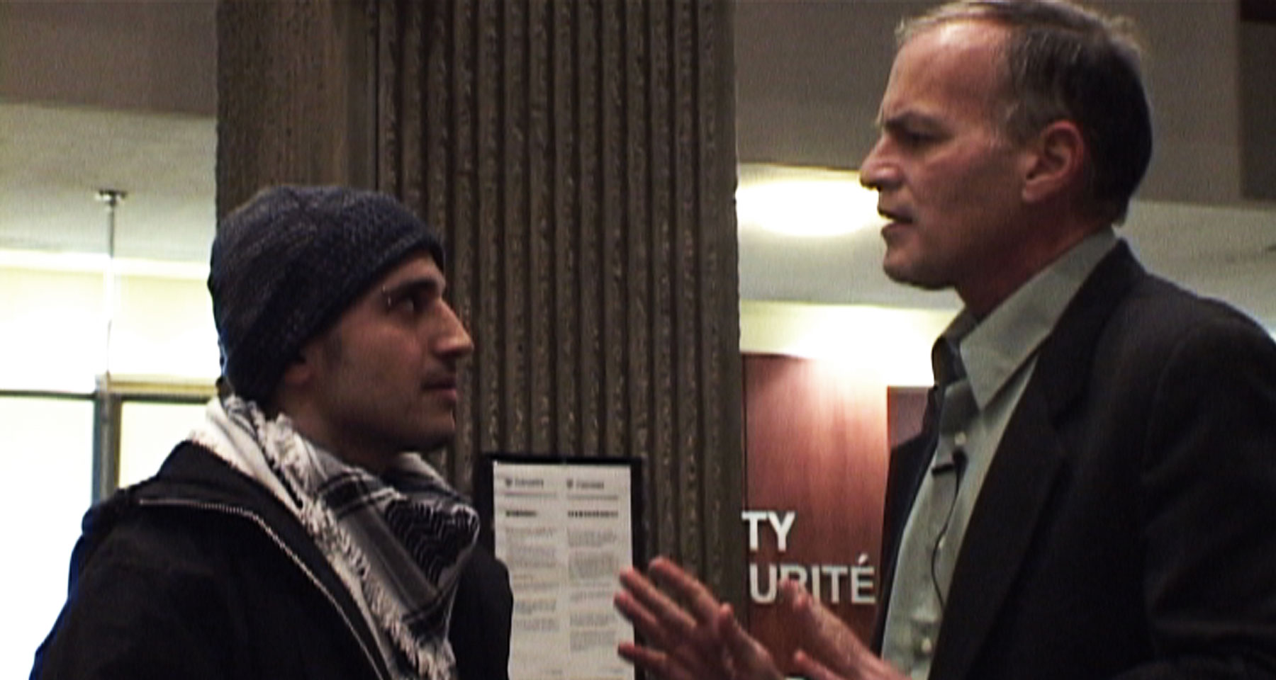 Norman speaks to a student at the University of Waterloo