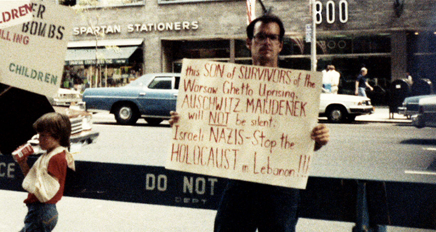 Norman holding a sign at a protest