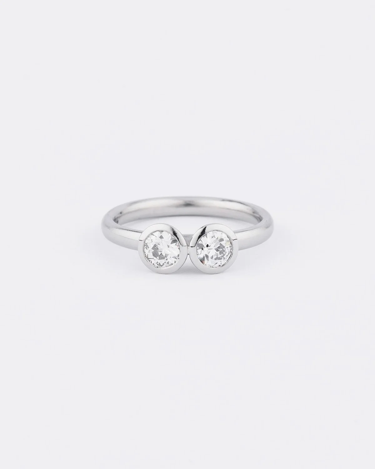 Using E &amp; A&rsquo;s own diamonds from a vintage piece, we transformed them into a contemporary platinum ring with rubover settings - a pared back take on the classic two-stone ring. Love! ✔️
