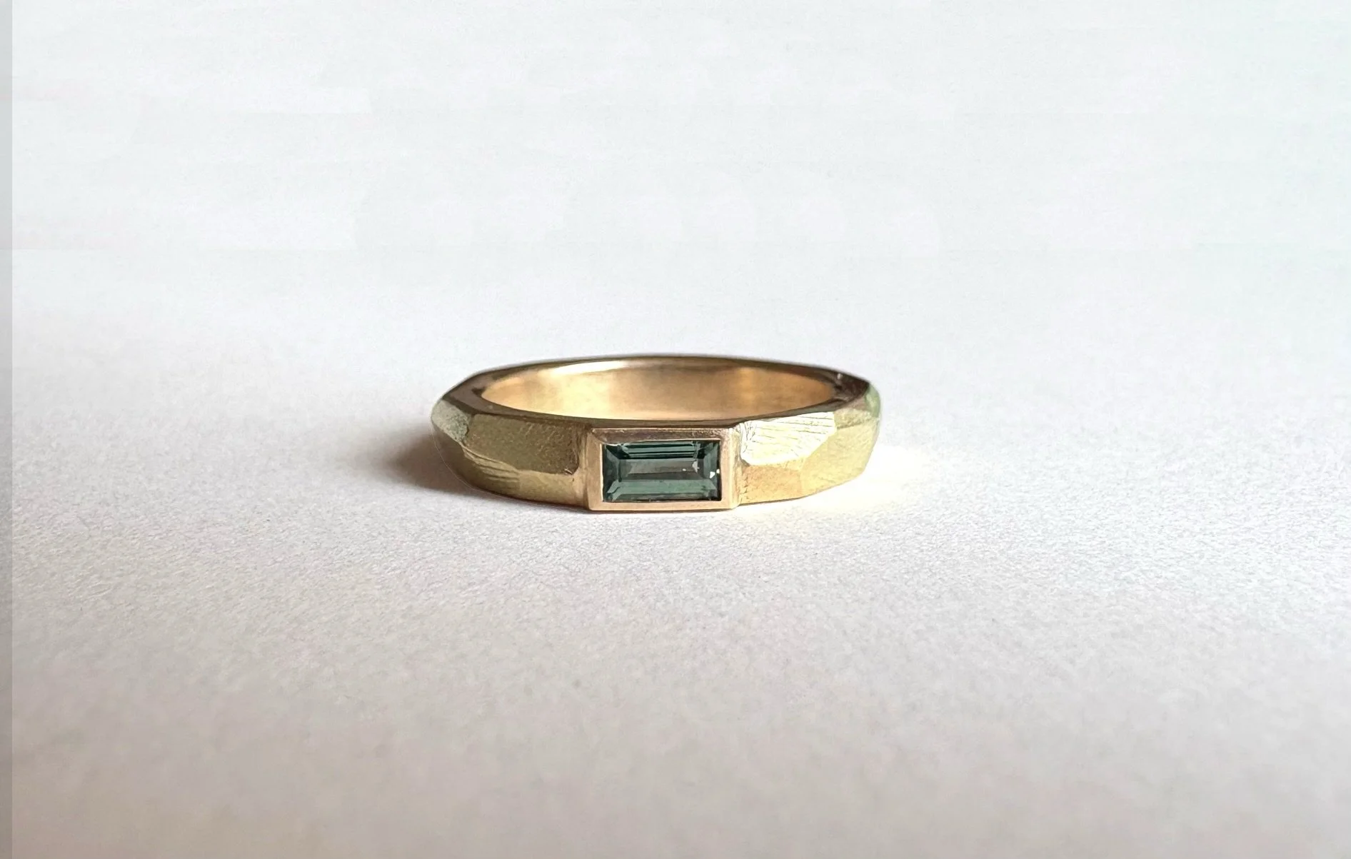 A recent remodel ✨

W &amp; A&rsquo;s own 22ct gold, alloyed down to 14ct yellow gold and reworked into a Geo Carved Ring, with a gorgeous green baguette sapphire.

I love this one, such a pleasure to make!