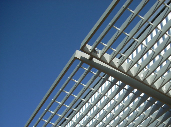 Exterior solar shading devices are fabricated from industrial bar grating.