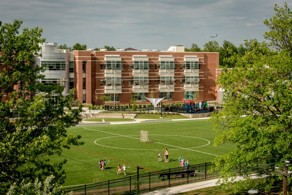 The new school is framed by the mature trees of its historic neighborhood in Old Town Alexandria.